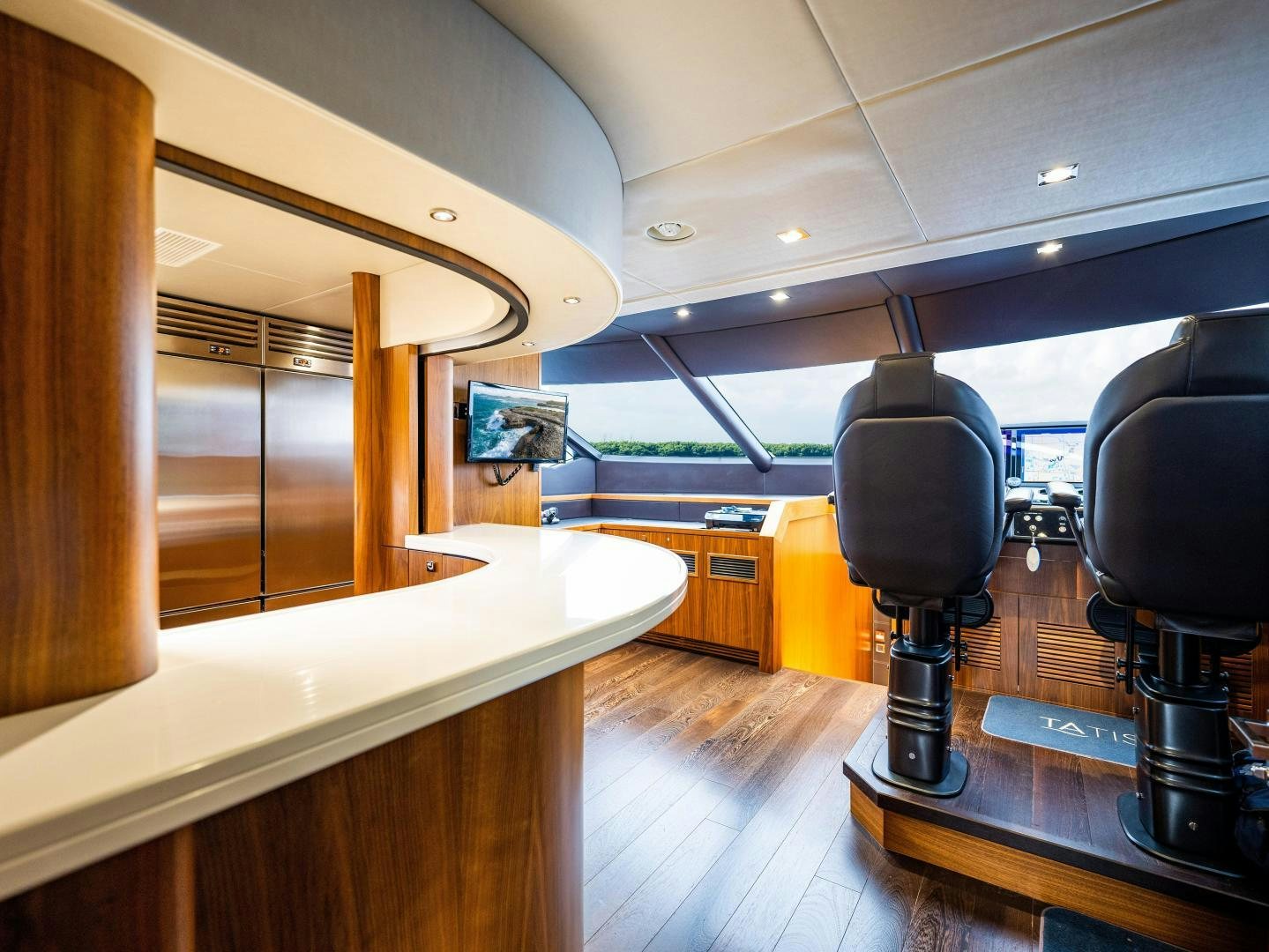 a room with a large mirror and a large black chair aboard TATIS Yacht for Sale