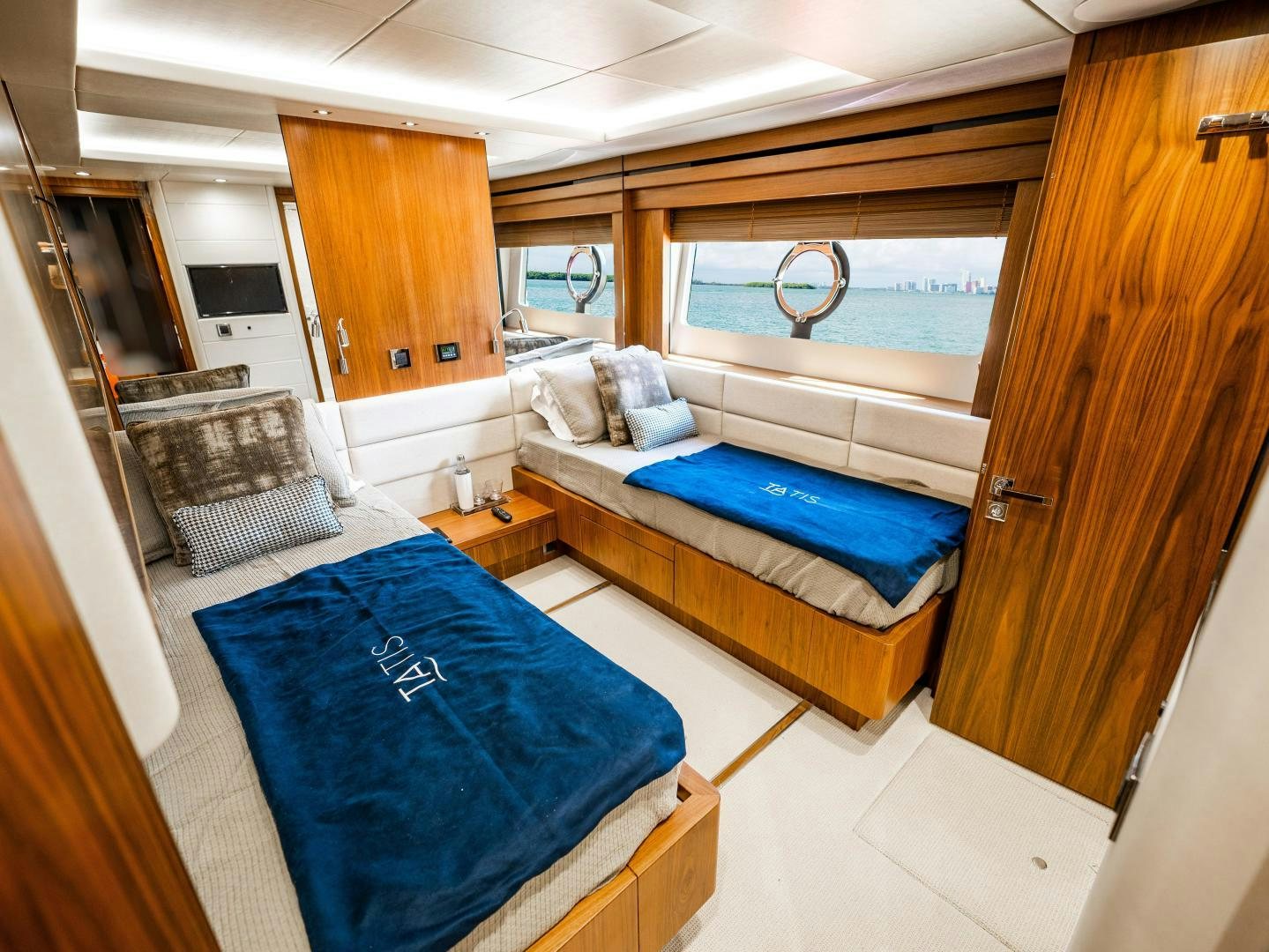 a room with a bed and a chair aboard TATIS Yacht for Sale