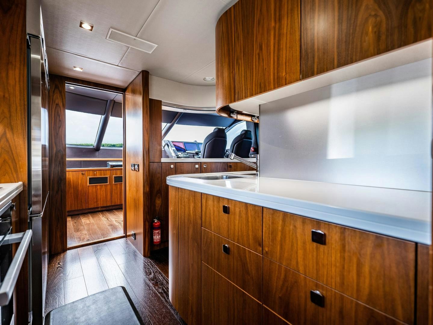 a kitchen with wooden cabinets aboard TATIS Yacht for Sale