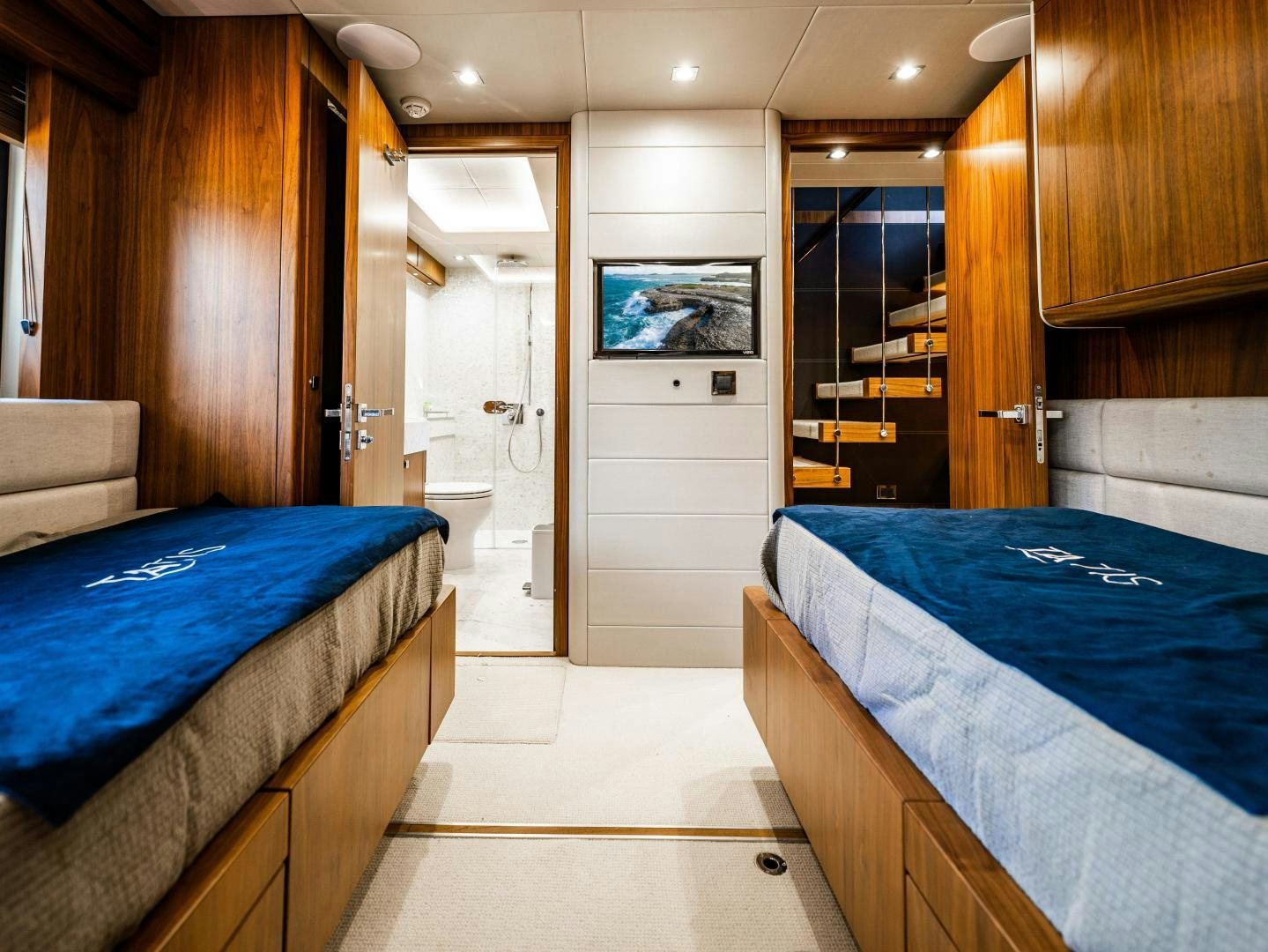 a bedroom with a bed and a closet aboard TATIS Yacht for Sale