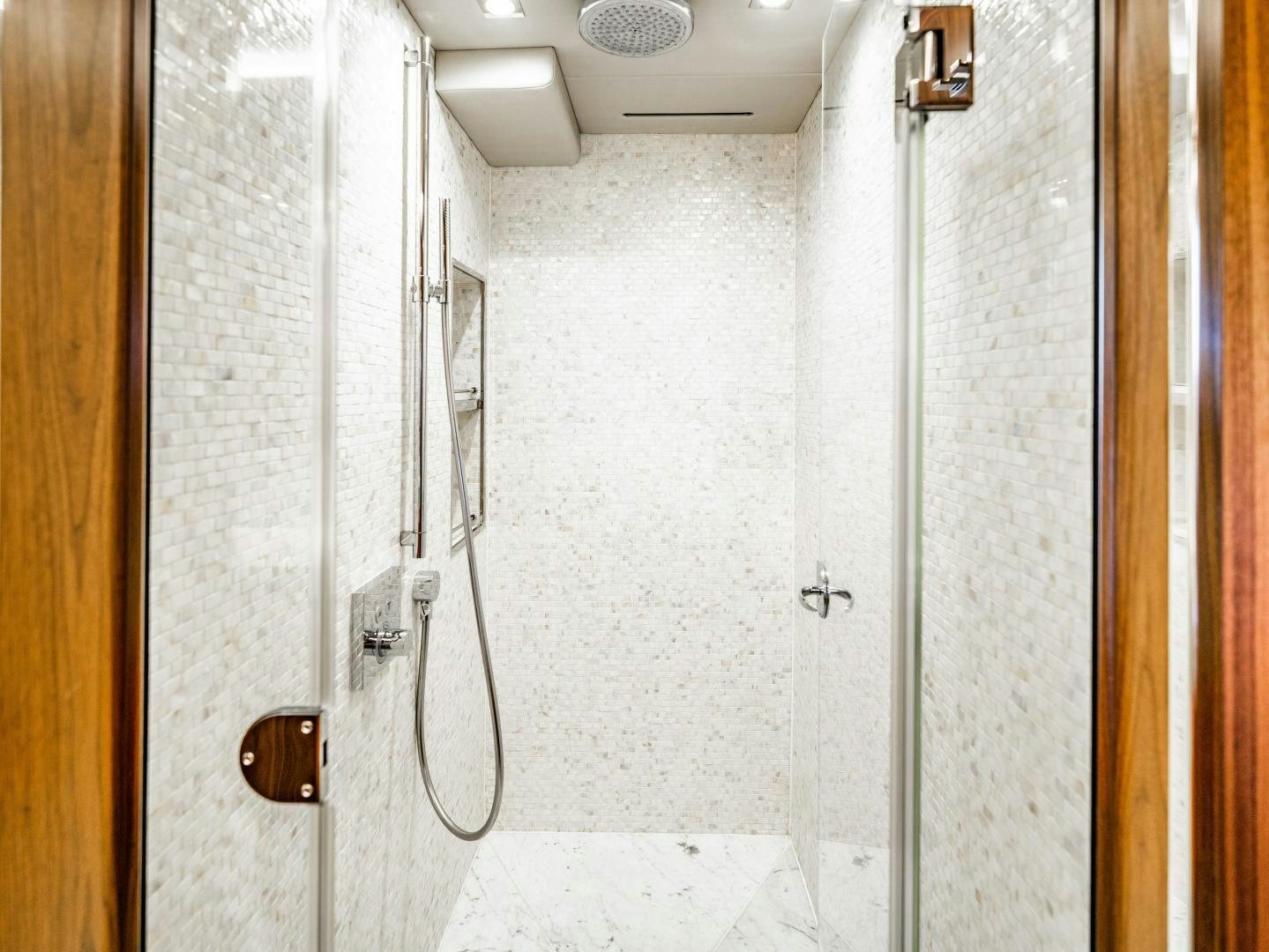 a hallway with a door and a light on the wall aboard TATIS Yacht for Sale