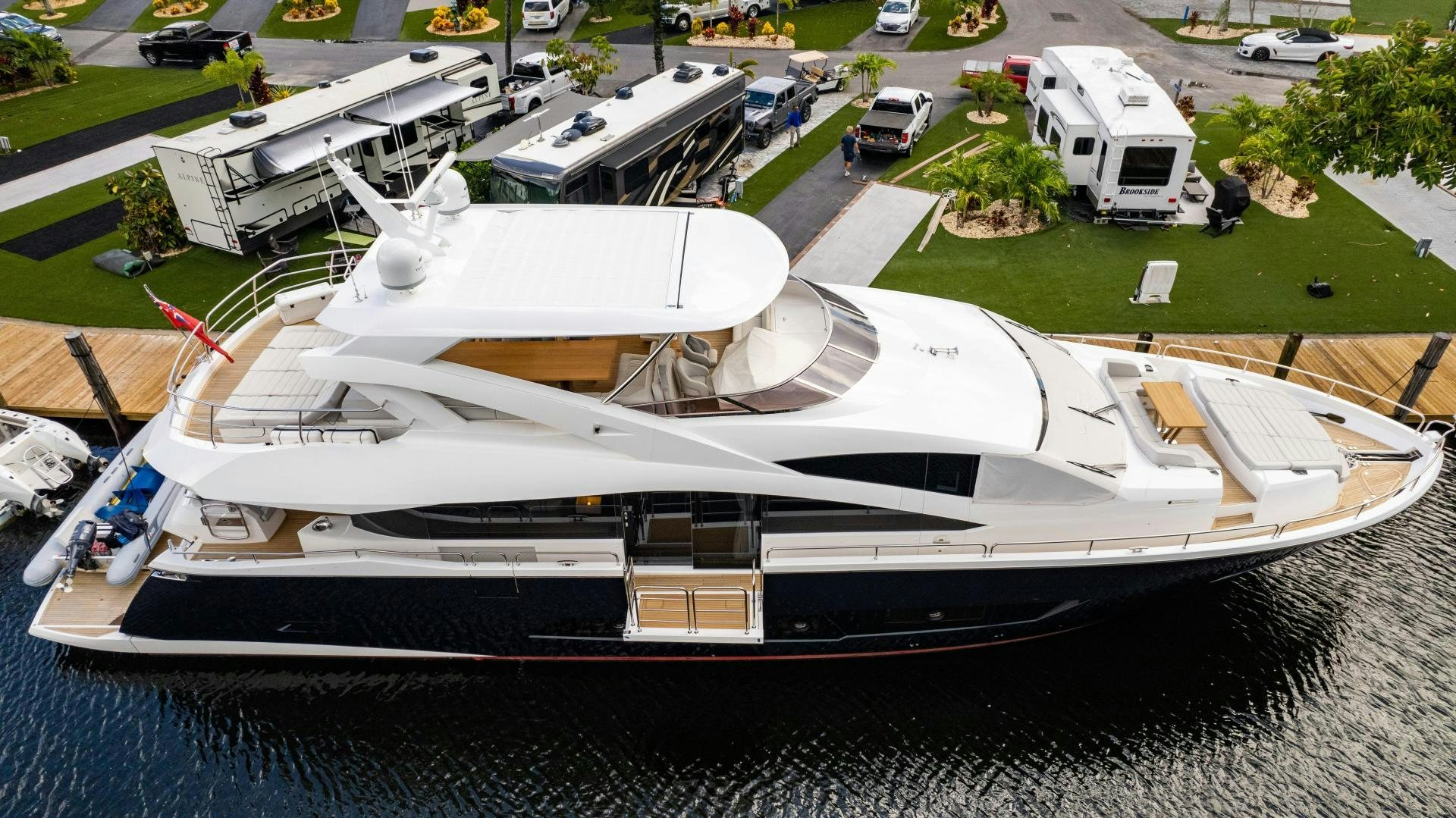 a large white yacht in a parking lot aboard TATIS Yacht for Sale