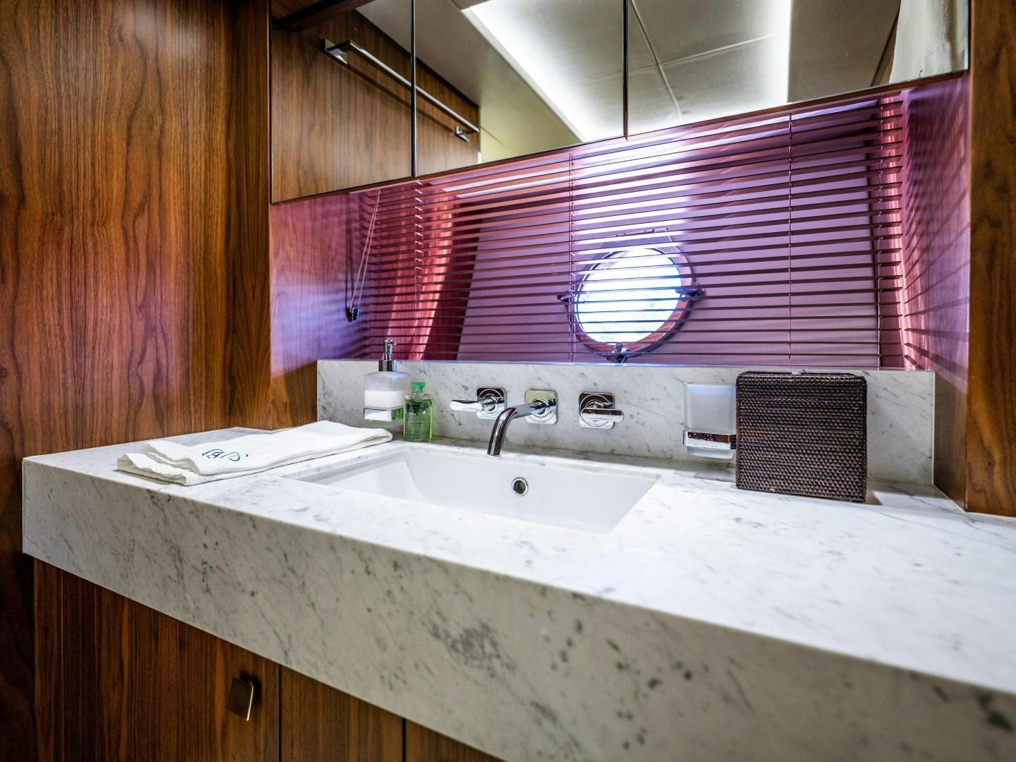 a bathroom with a sink and a mirror aboard TATIS Yacht for Sale