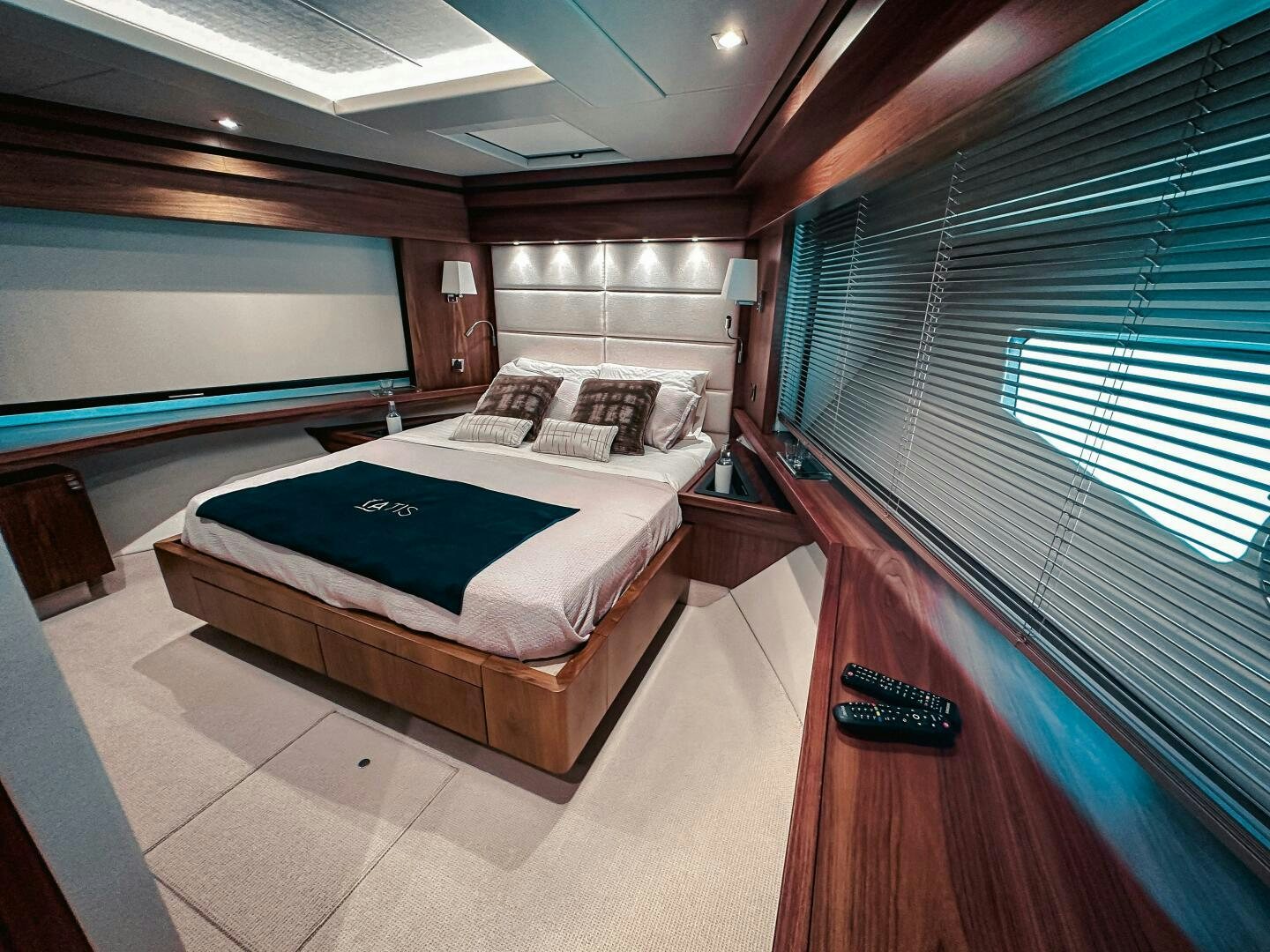 a room with a bed and a television aboard TATIS Yacht for Sale