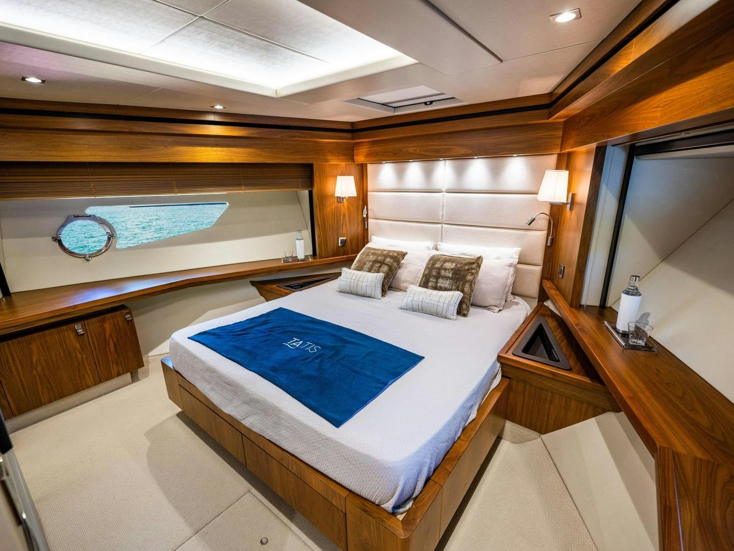 a room with a bed and a large mirror aboard TATIS Yacht for Sale