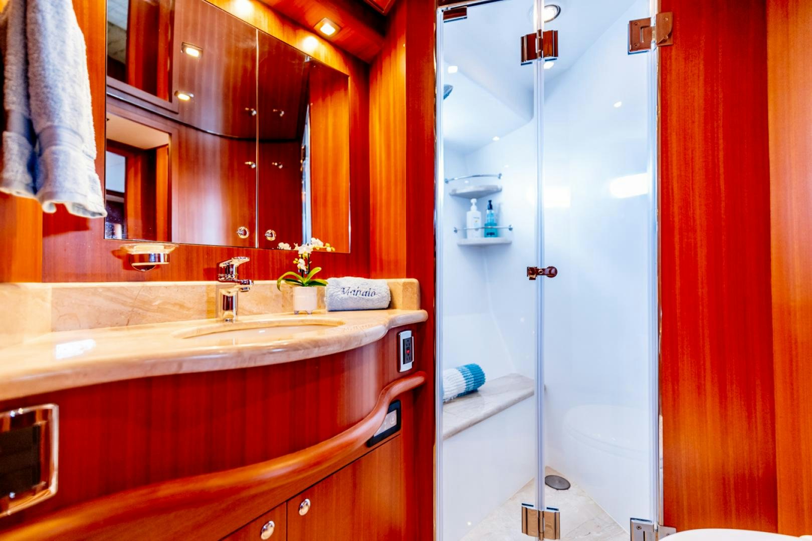 a bathroom with a glass shower aboard MAHALO Yacht for Sale