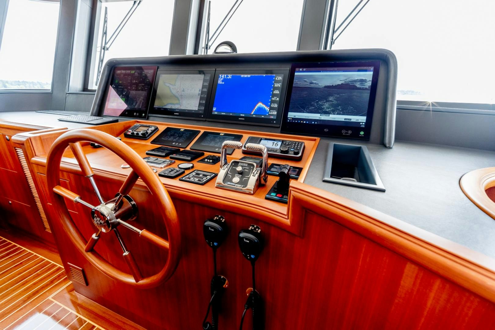 a wooden desk with computers and electronics aboard MAHALO Yacht for Sale