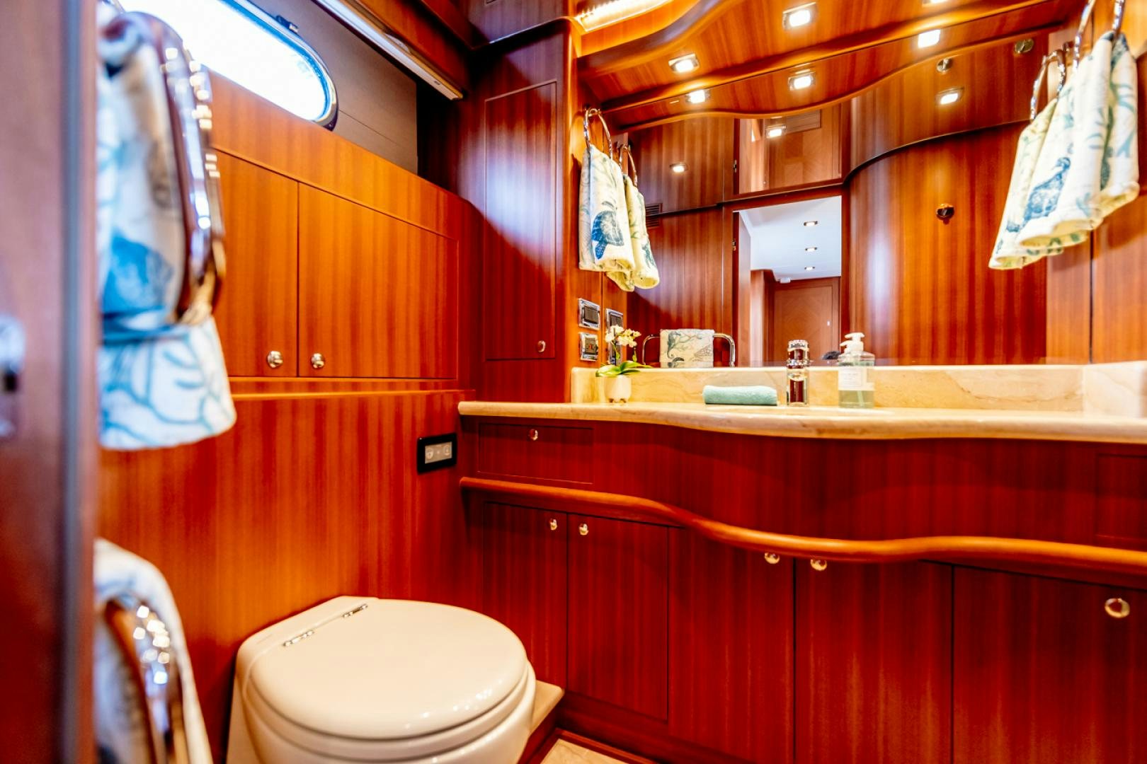 a bathroom with a mirror and a toilet aboard MAHALO Yacht for Sale