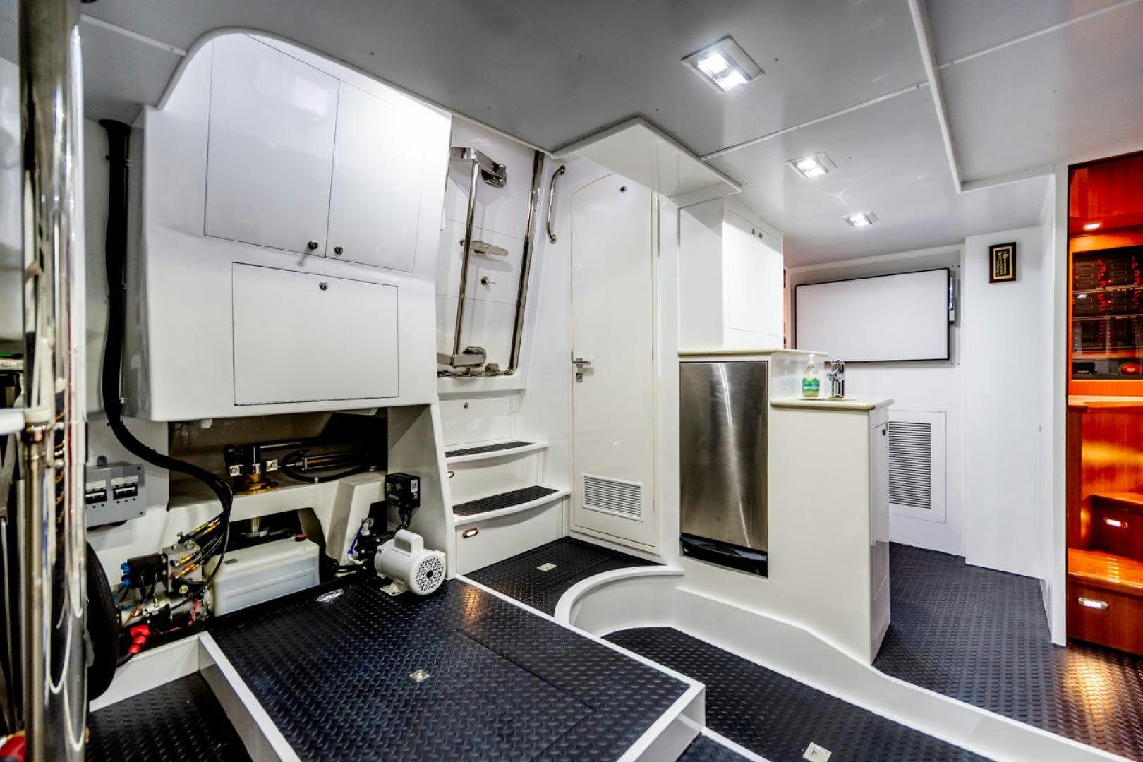 a room with a large black and white machine and a black floor aboard MAHALO Yacht for Sale