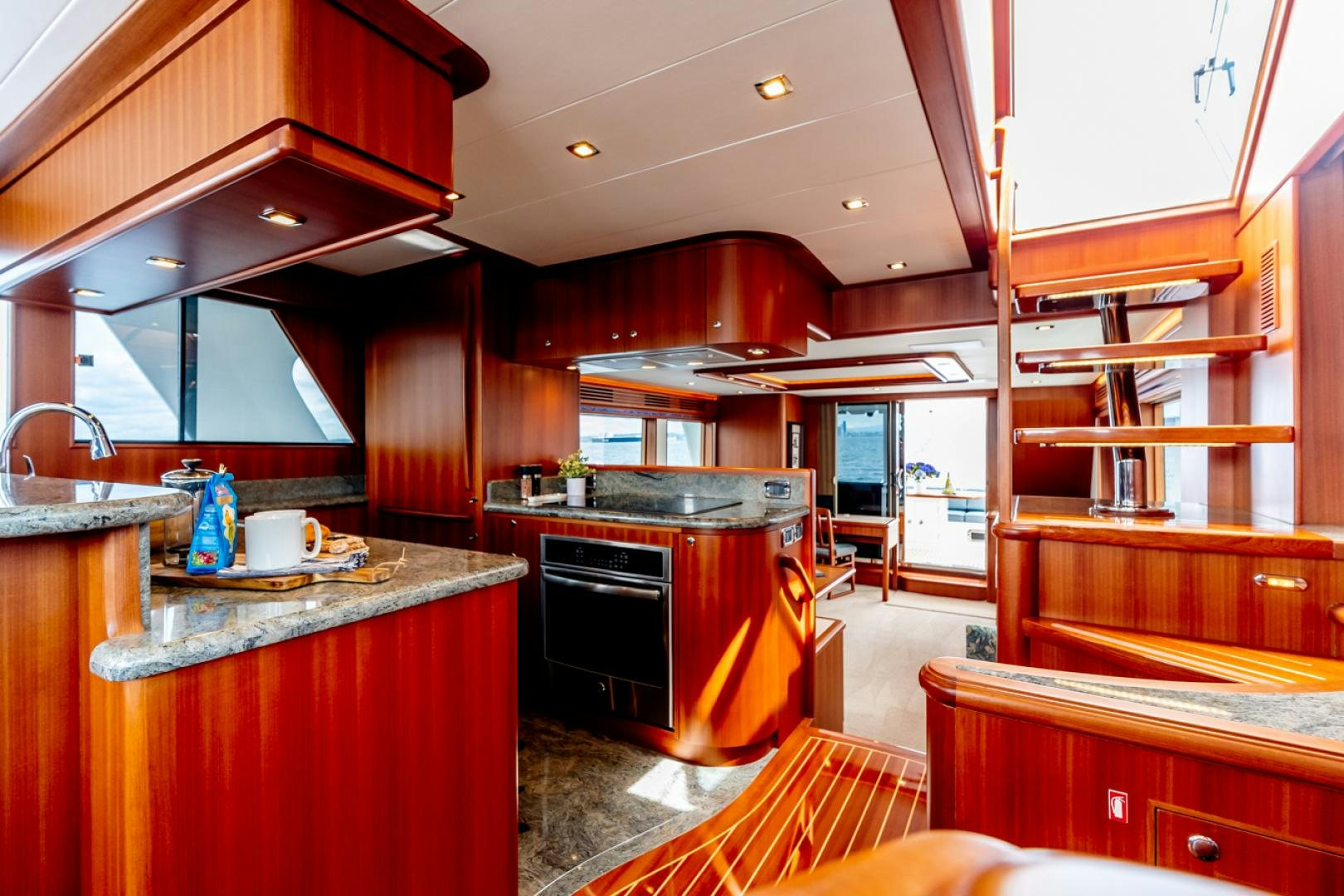 a kitchen with wooden cabinets aboard MAHALO Yacht for Sale