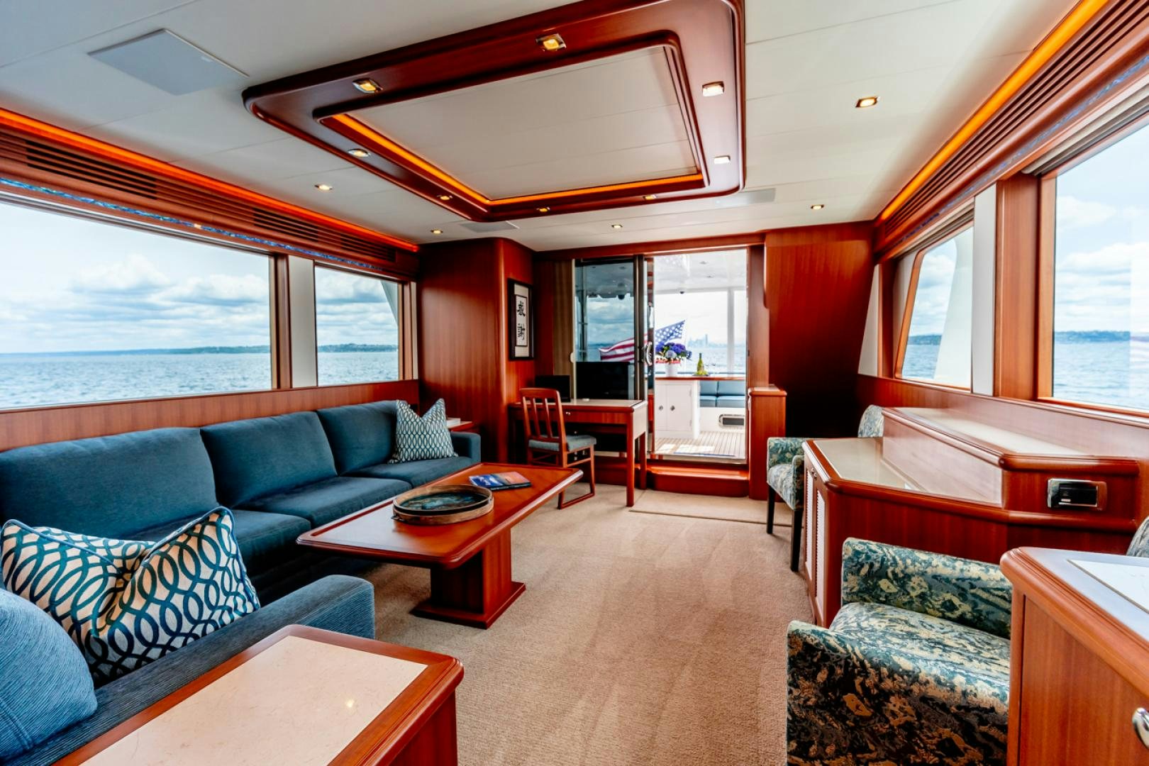 a living room with a blue couch aboard MAHALO Yacht for Sale