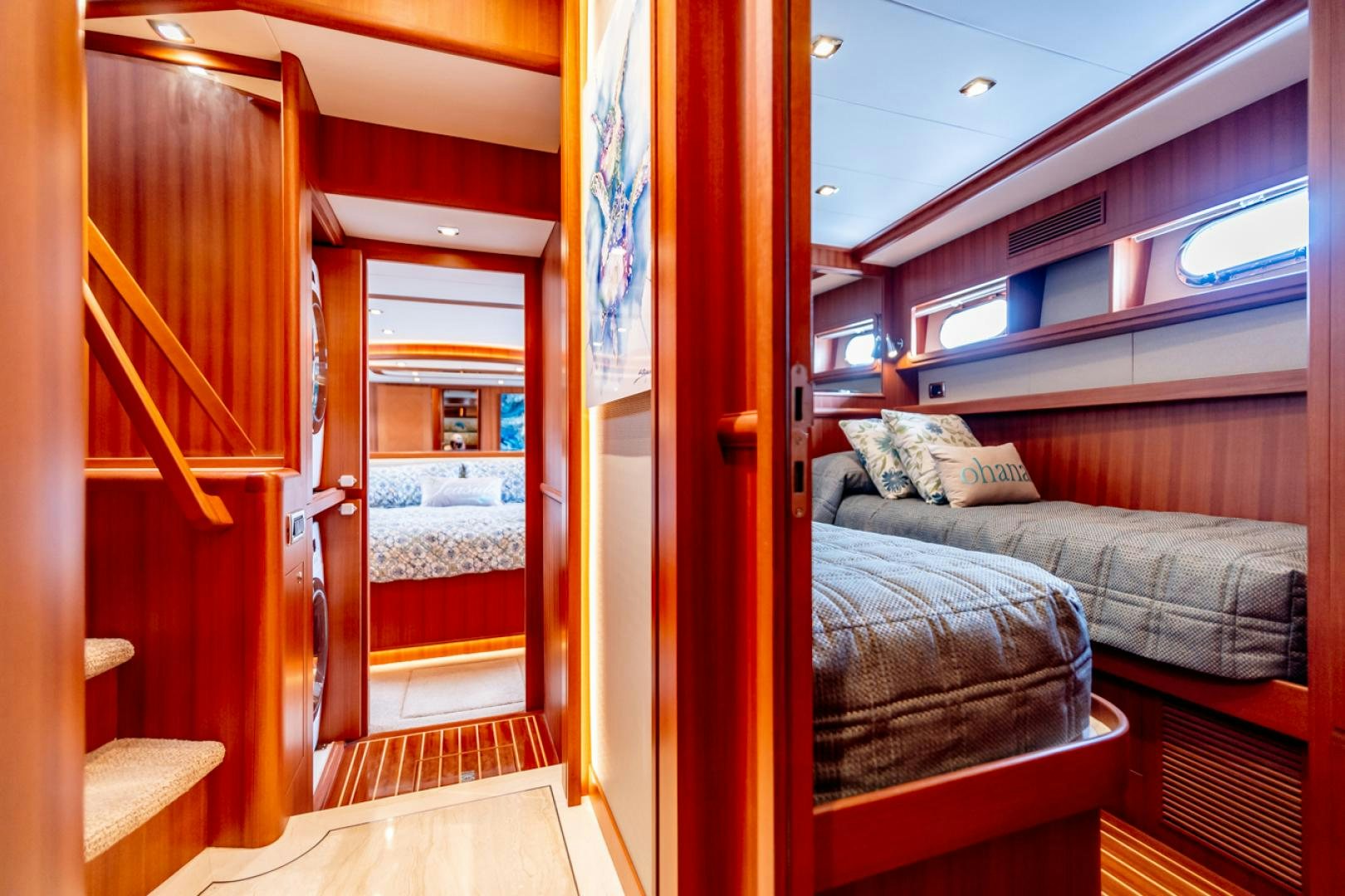 a bedroom with a bed and a closet aboard MAHALO Yacht for Sale