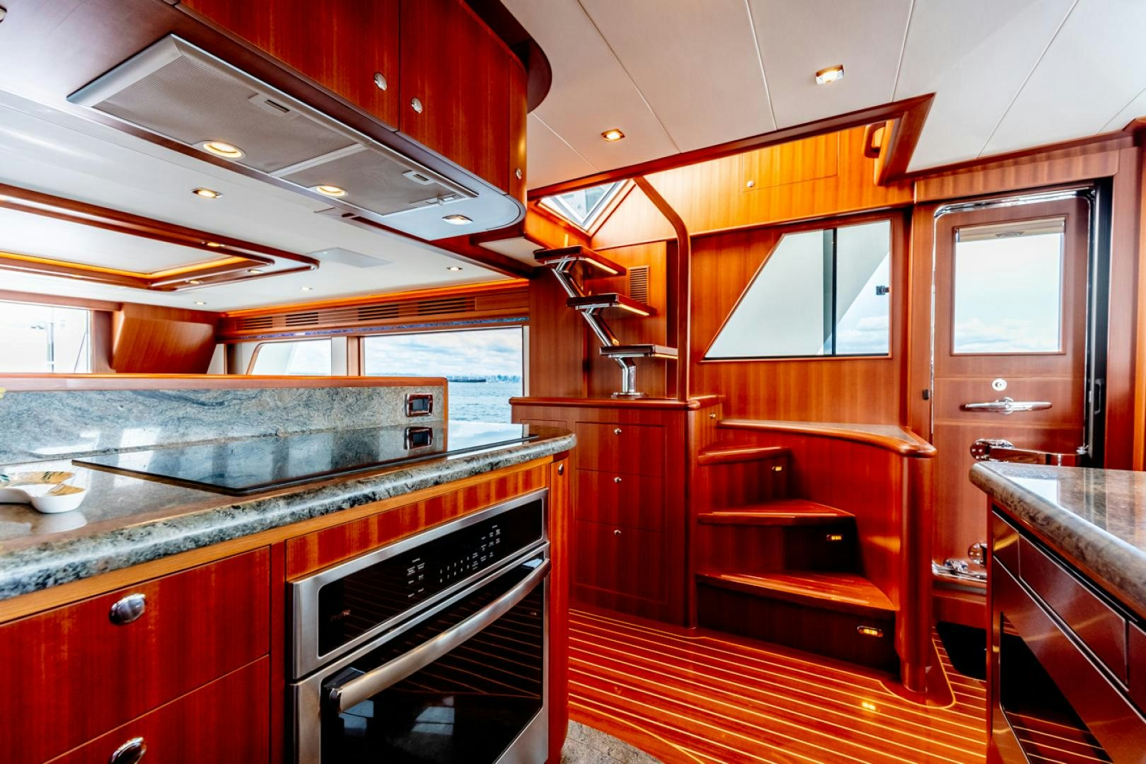 a kitchen with wooden cabinets aboard MAHALO Yacht for Sale