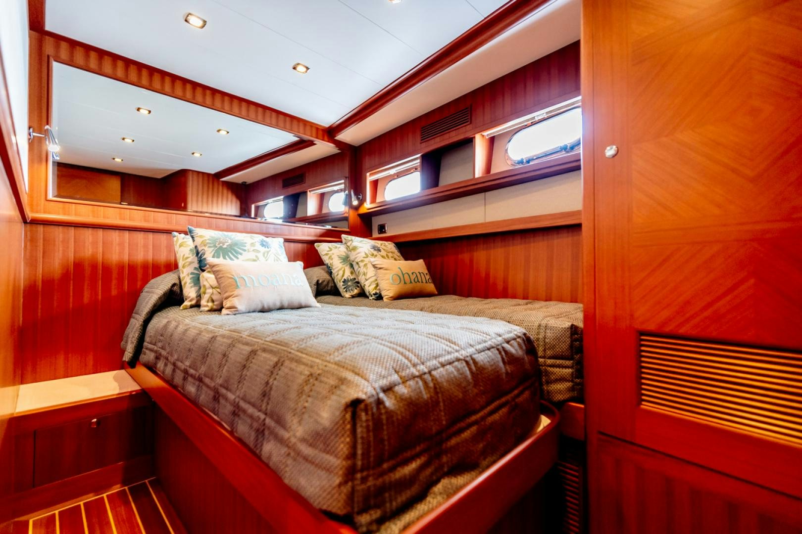 a bed with a couple of pillows aboard MAHALO Yacht for Sale
