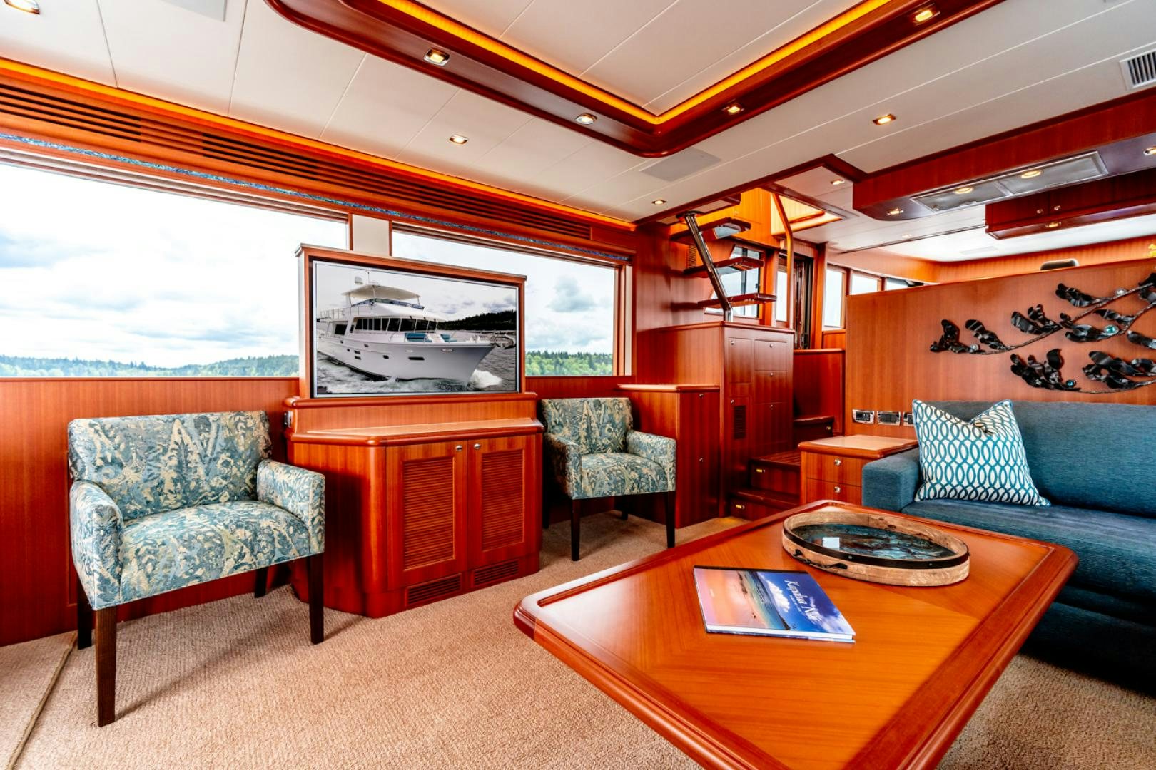 a living room with a couch and a table aboard MAHALO Yacht for Sale
