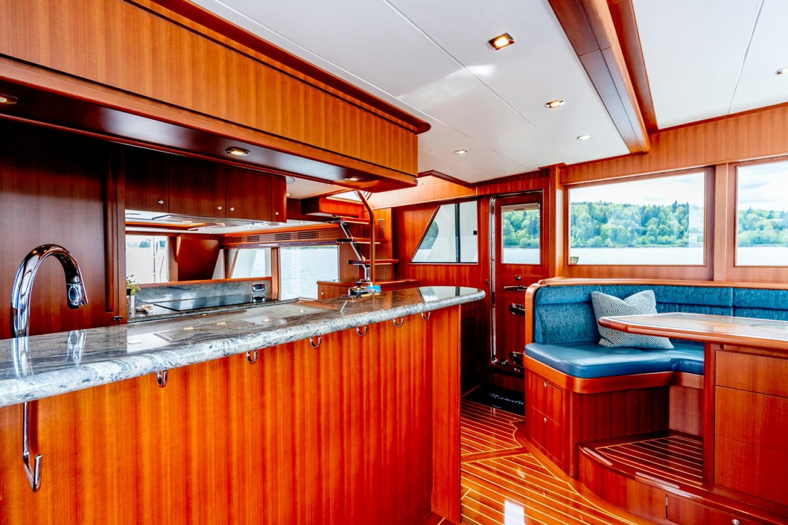 a kitchen with a sink and a couch aboard MAHALO Yacht for Sale