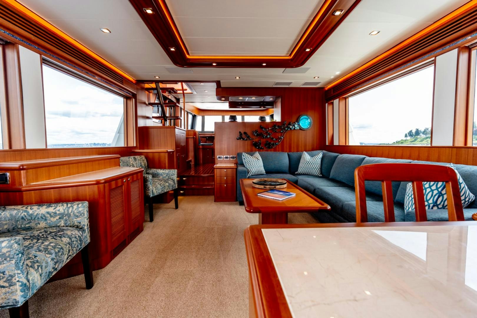 a living room with a couch and a table aboard MAHALO Yacht for Sale