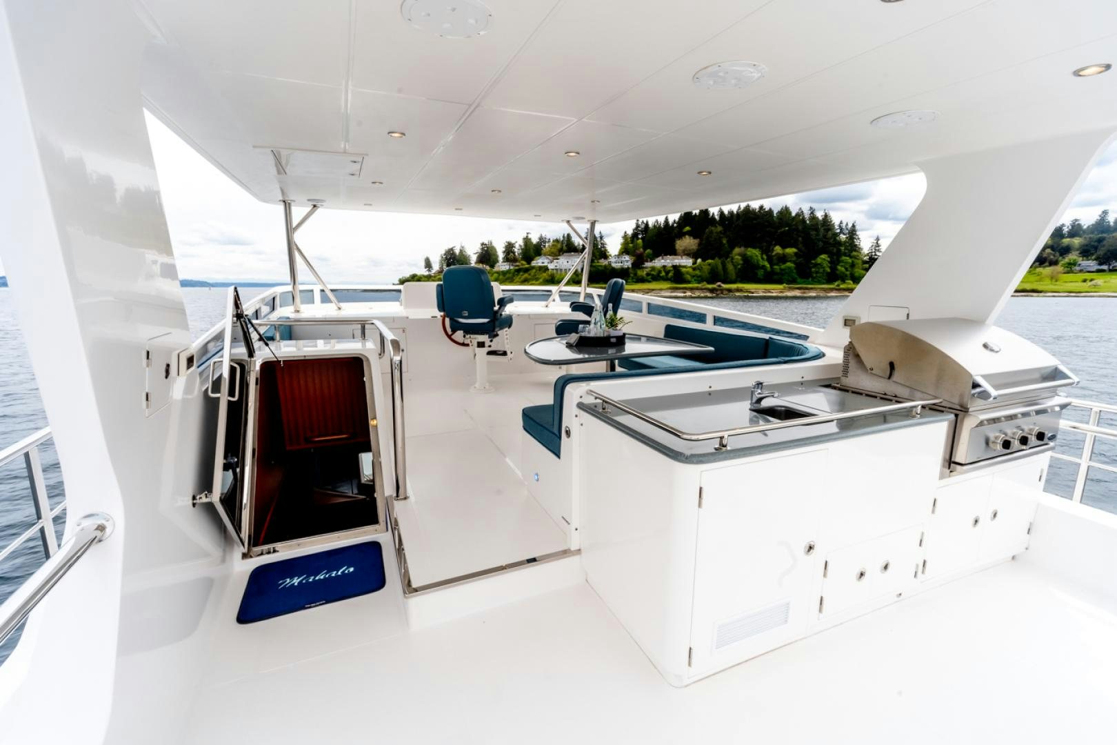 a room with a table and chairs aboard MAHALO Yacht for Sale