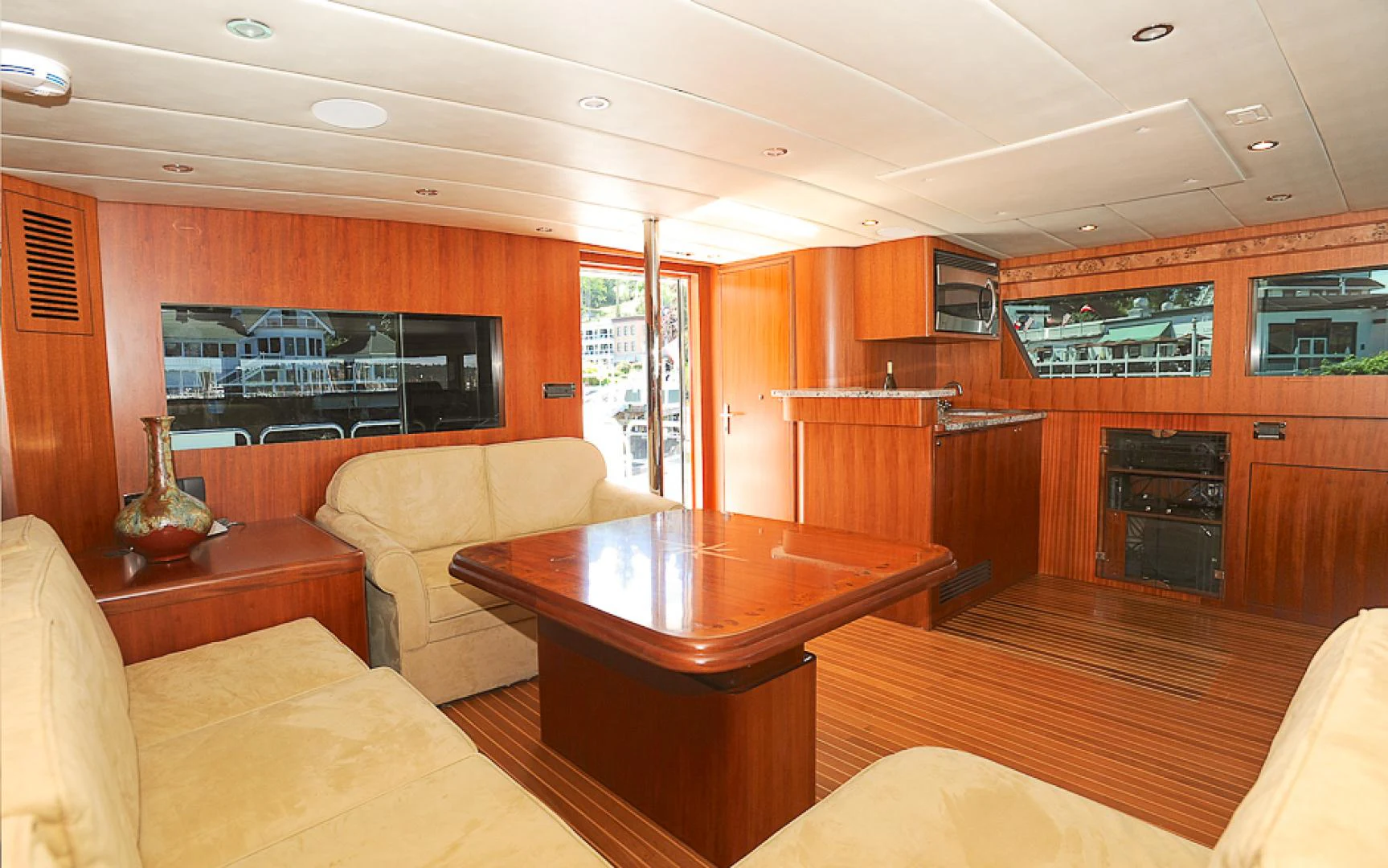 a living room with wood cabinets aboard MARANATHA Yacht for Sale