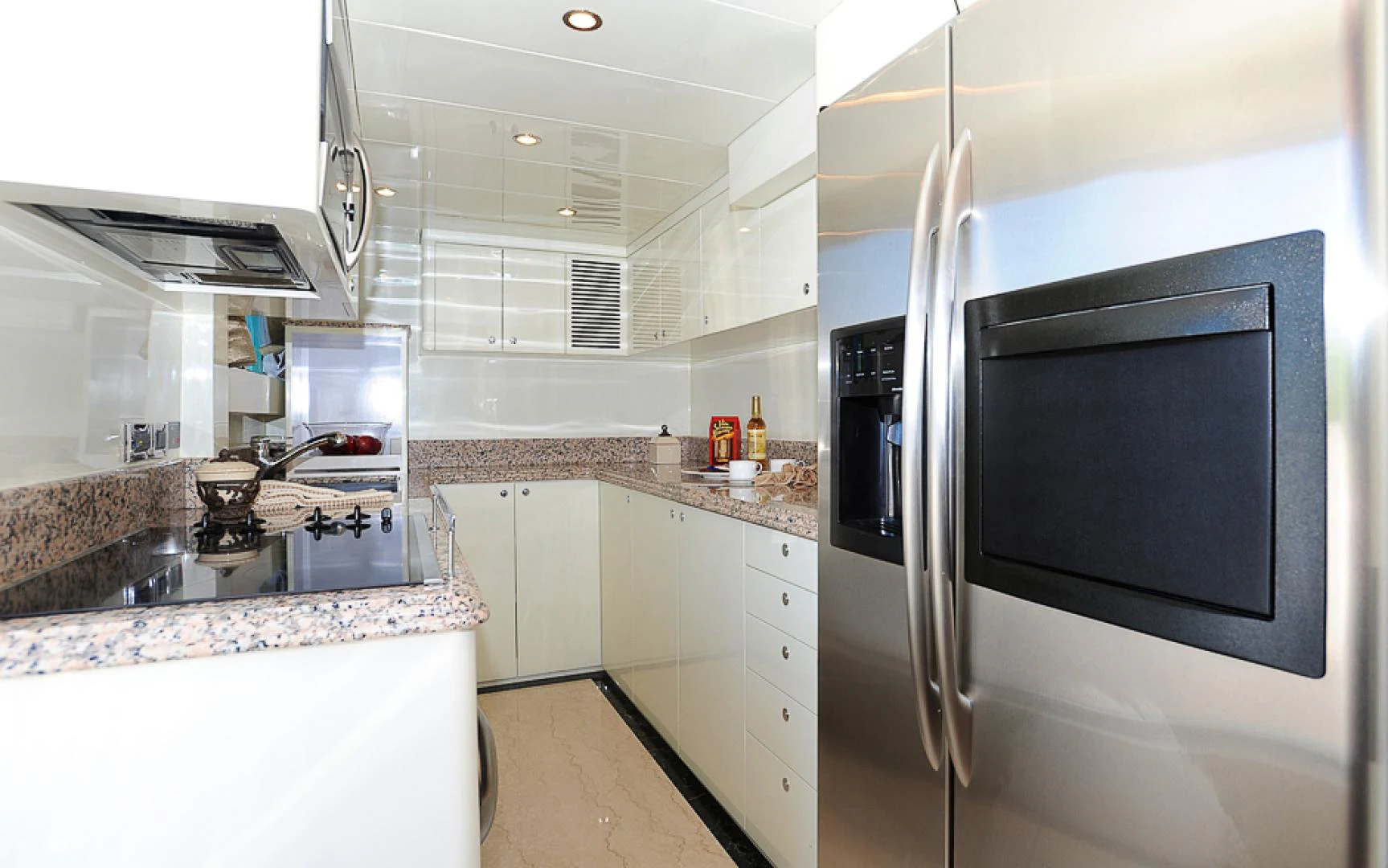 a kitchen with a microwave oven and refrigerator aboard MARANATHA Yacht for Sale
