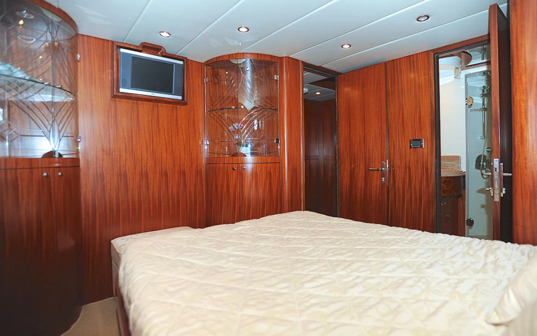 a bedroom with a bed and a television aboard MARANATHA Yacht for Sale