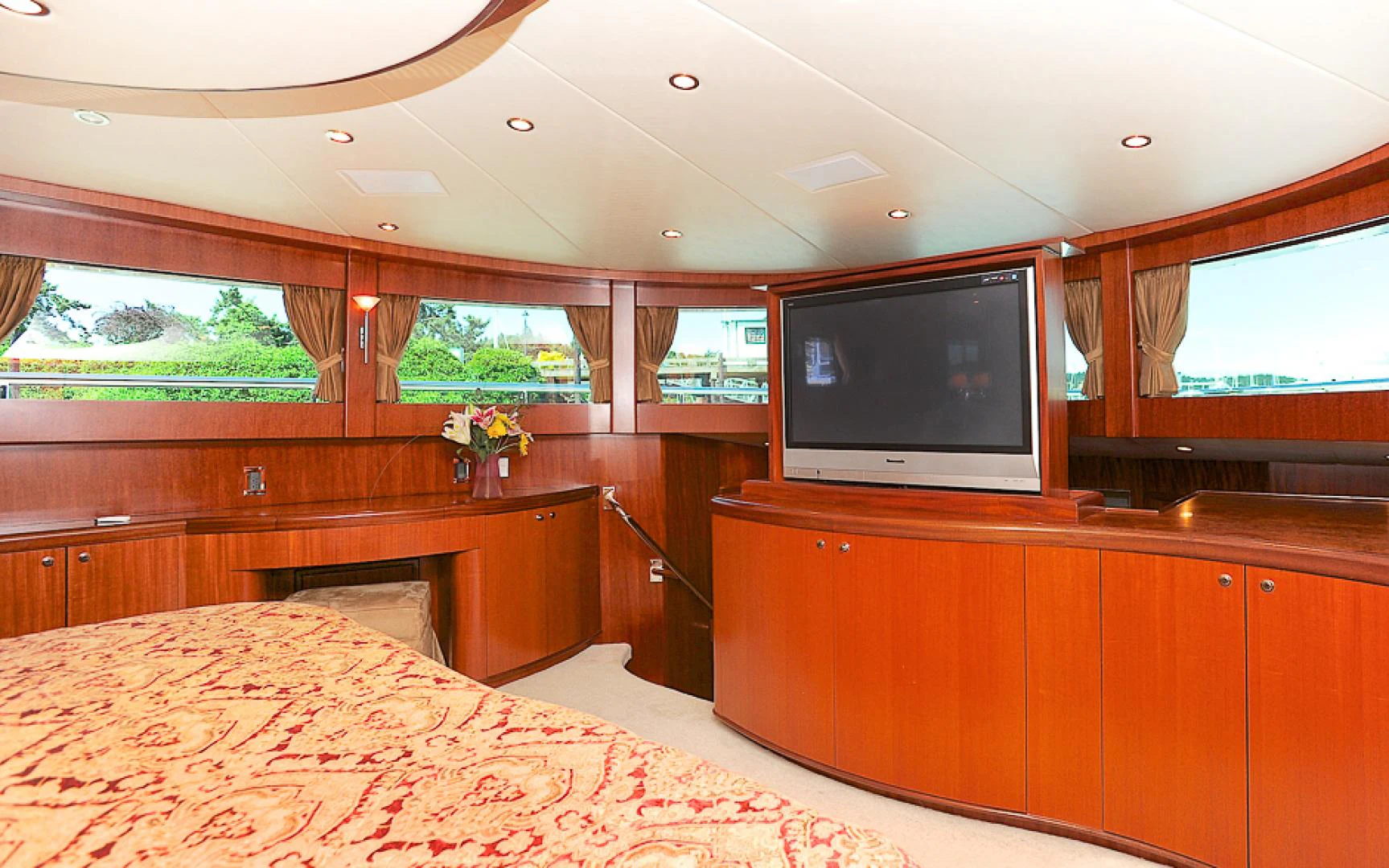 a bedroom with a tv on the wall aboard MARANATHA Yacht for Sale