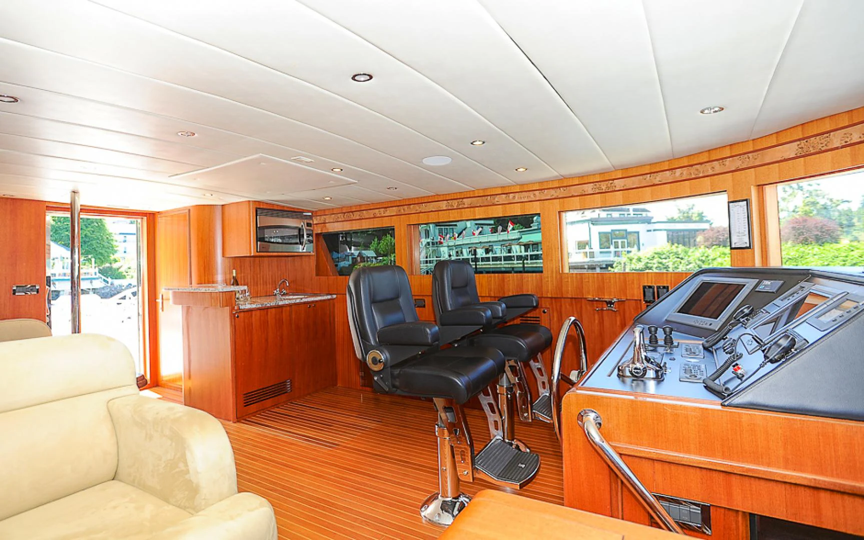 a room with a piano and a couch and a chair aboard MARANATHA Yacht for Sale