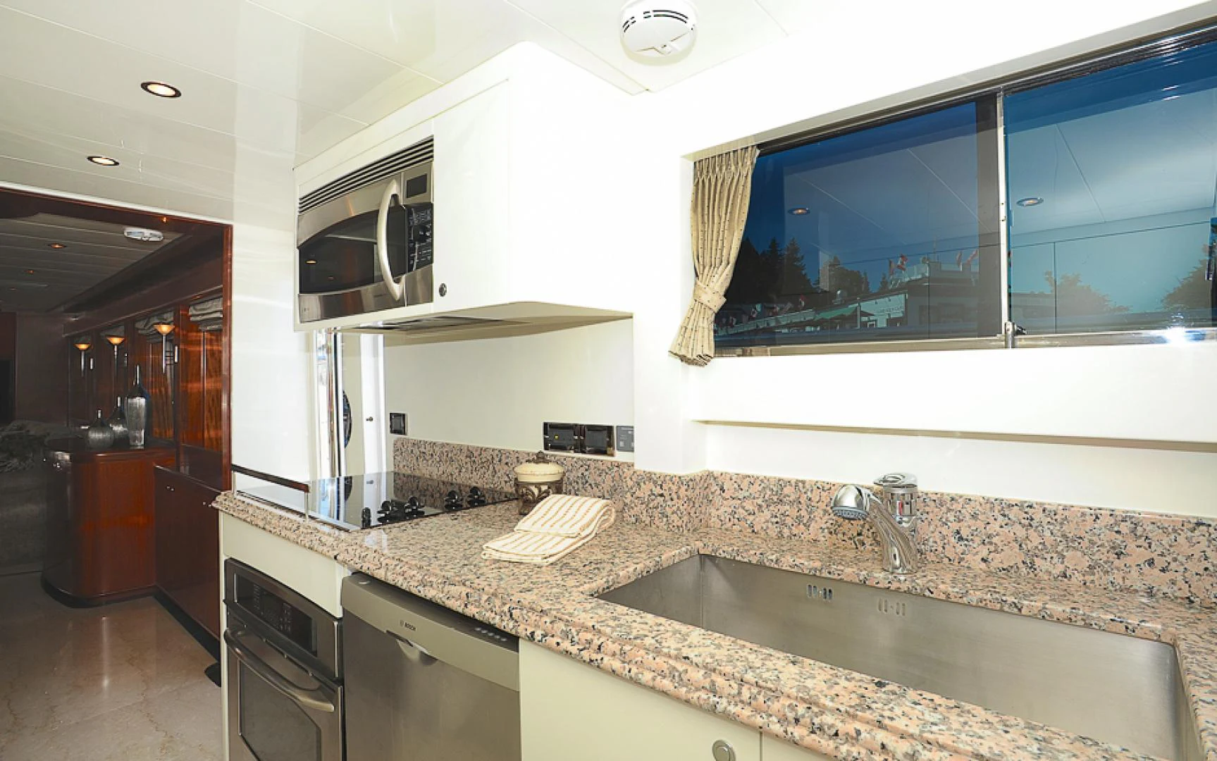 a kitchen with a marble counter top aboard MARANATHA Yacht for Sale