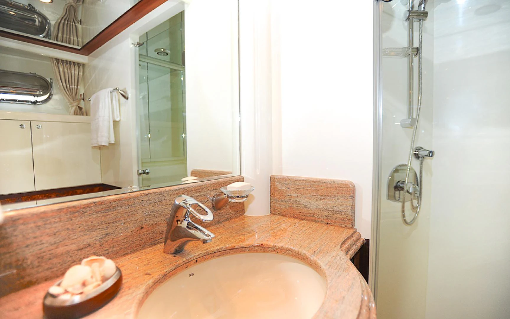 a bathroom with a sink and a mirror aboard MARANATHA Yacht for Sale