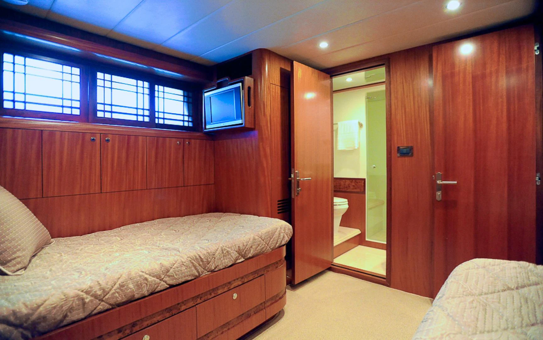a room with a bed and a television aboard MARANATHA Yacht for Sale