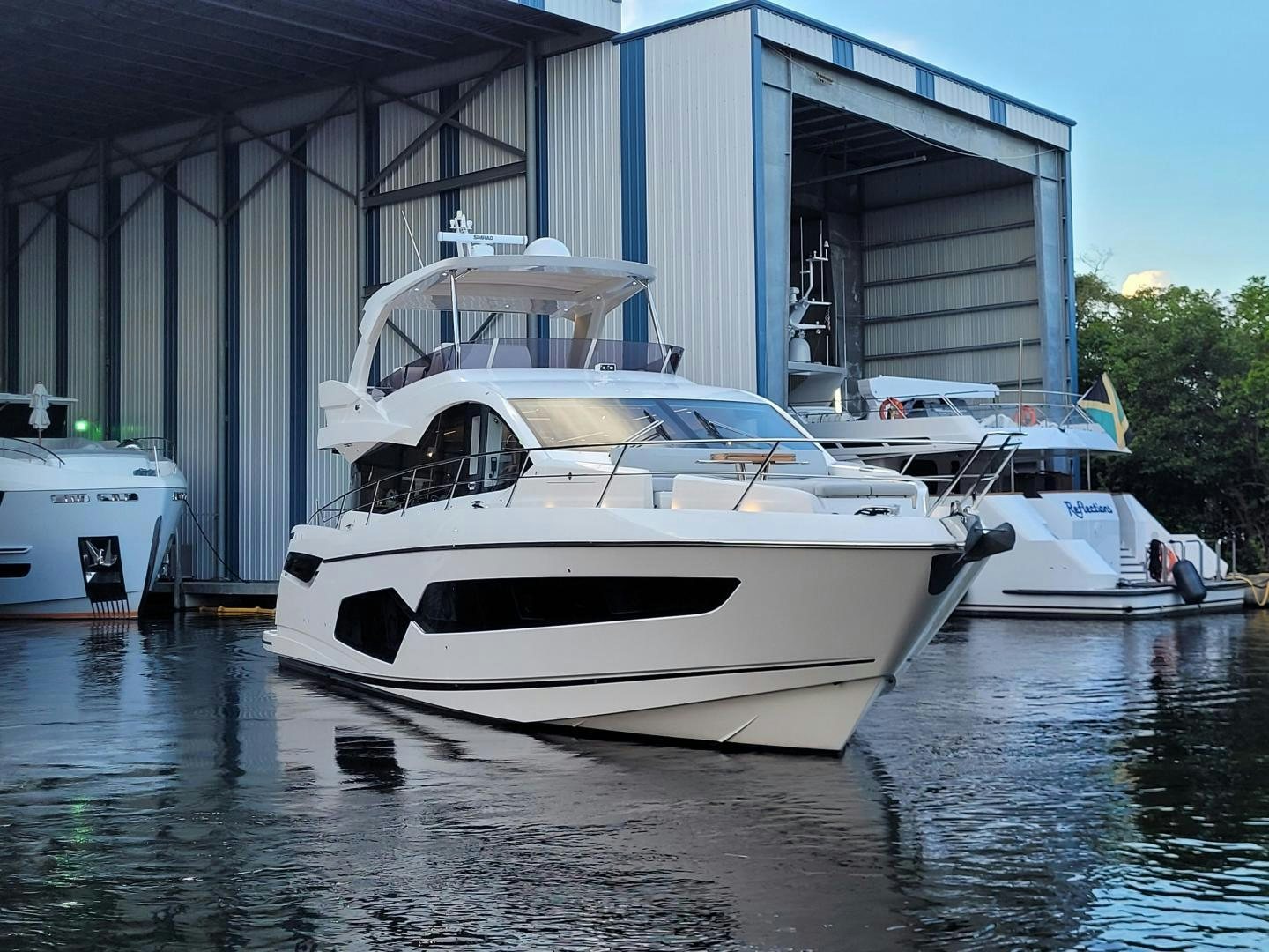 a white yacht in a harbor aboard DELICIA Yacht for Sale