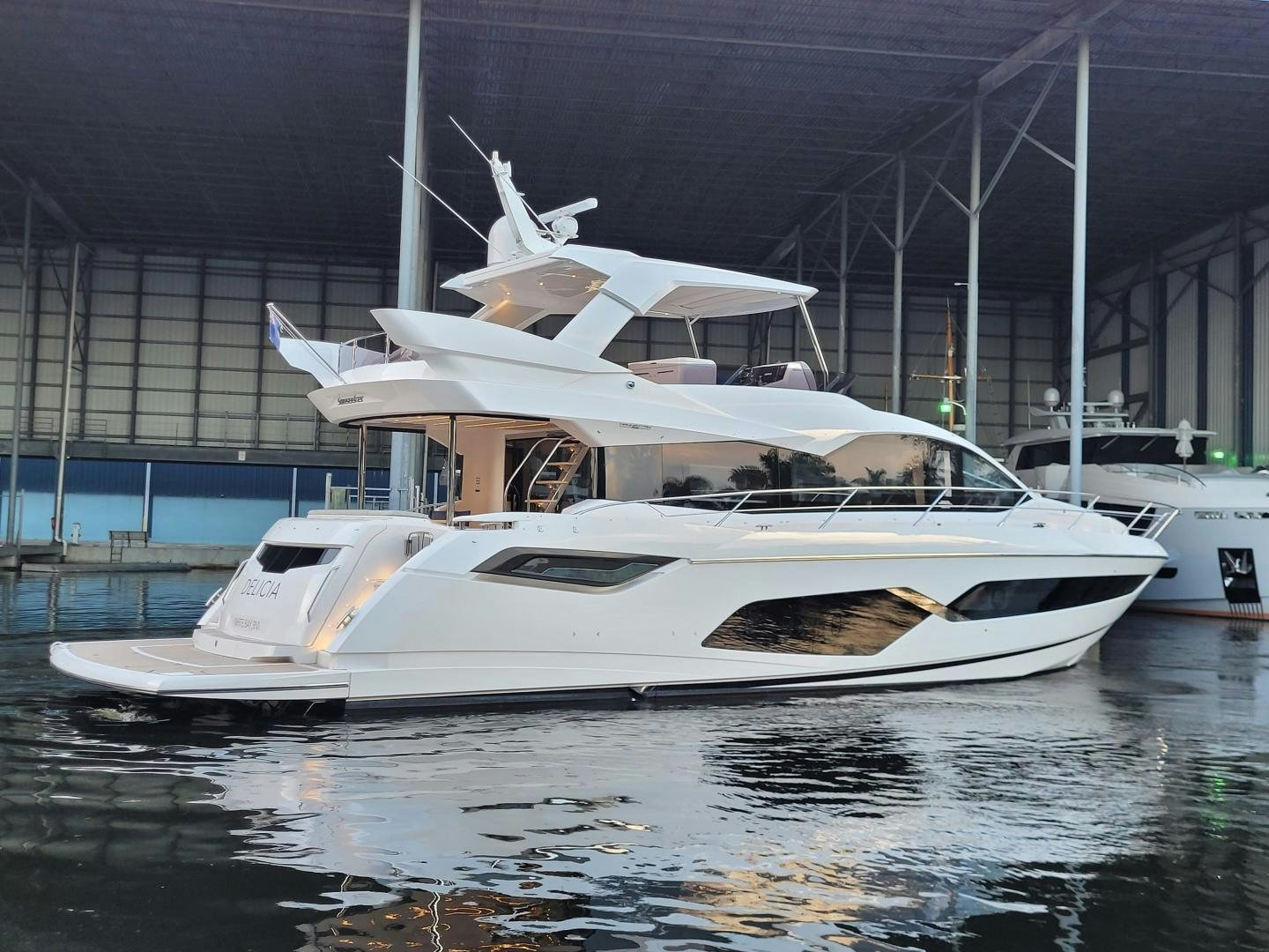 a white yacht in a harbor aboard DELICIA Yacht for Sale