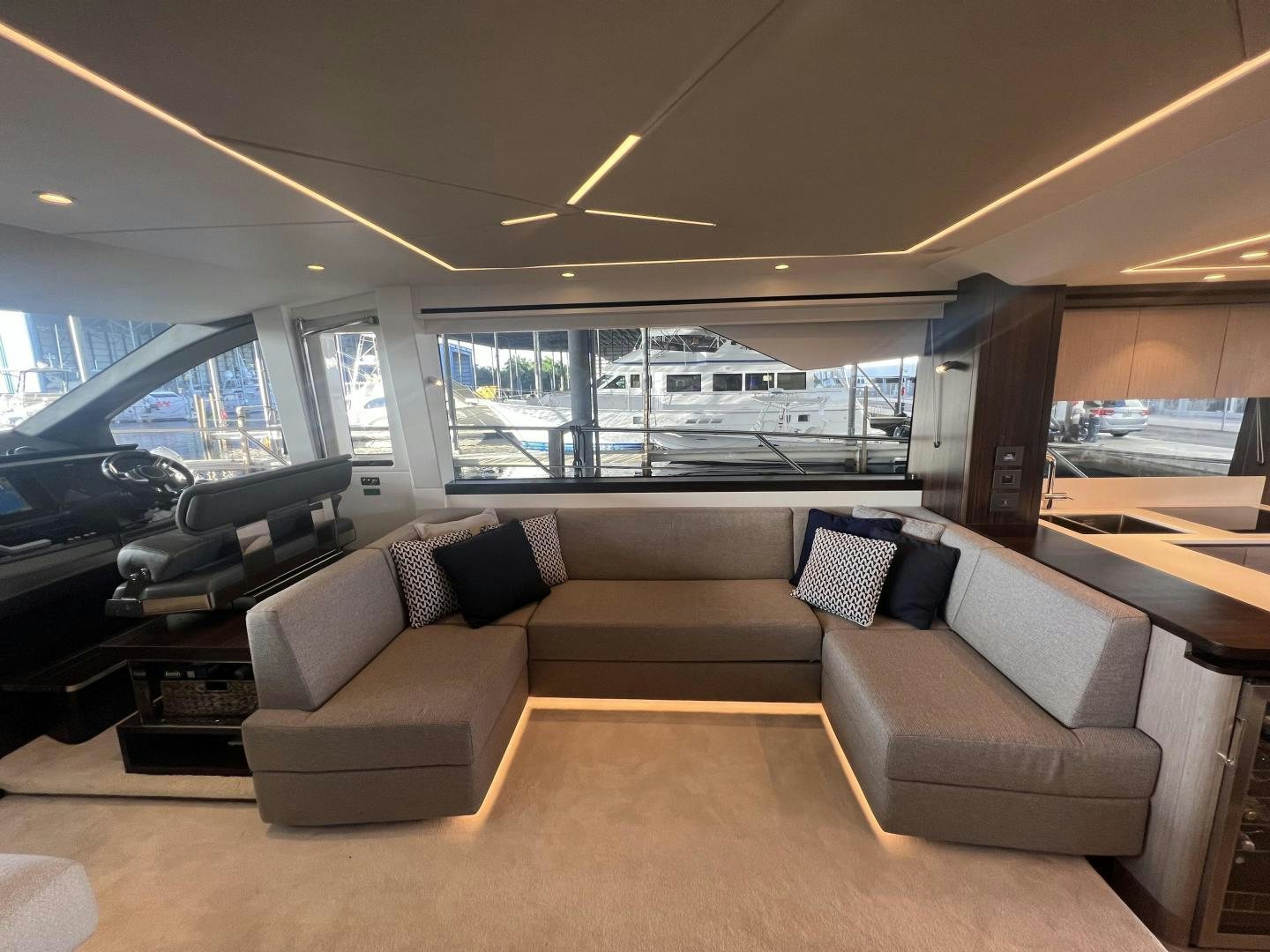 a living room with a couch and a large window aboard DELICIA Yacht for Sale