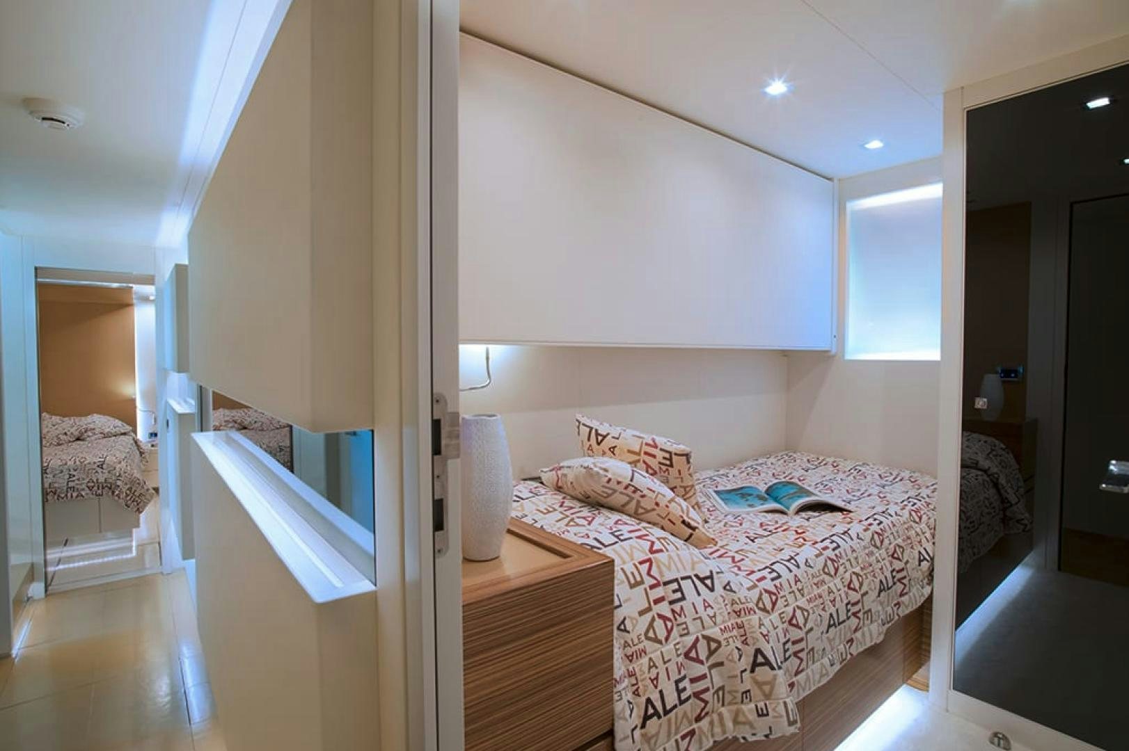 a bedroom with a bed and a mirror aboard ALE.MIA Yacht for Sale