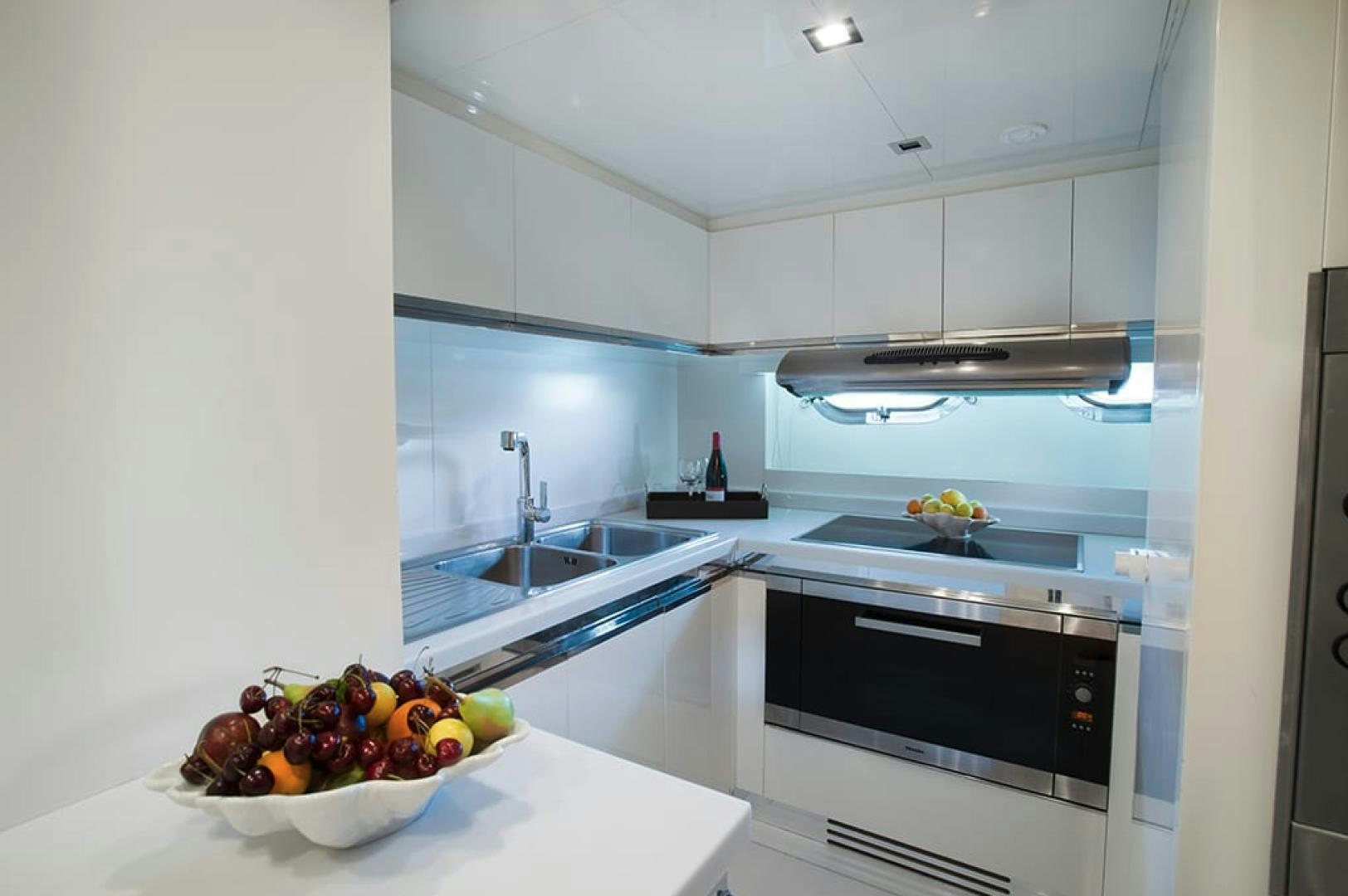 a kitchen with white cabinets aboard ALE.MIA Yacht for Sale