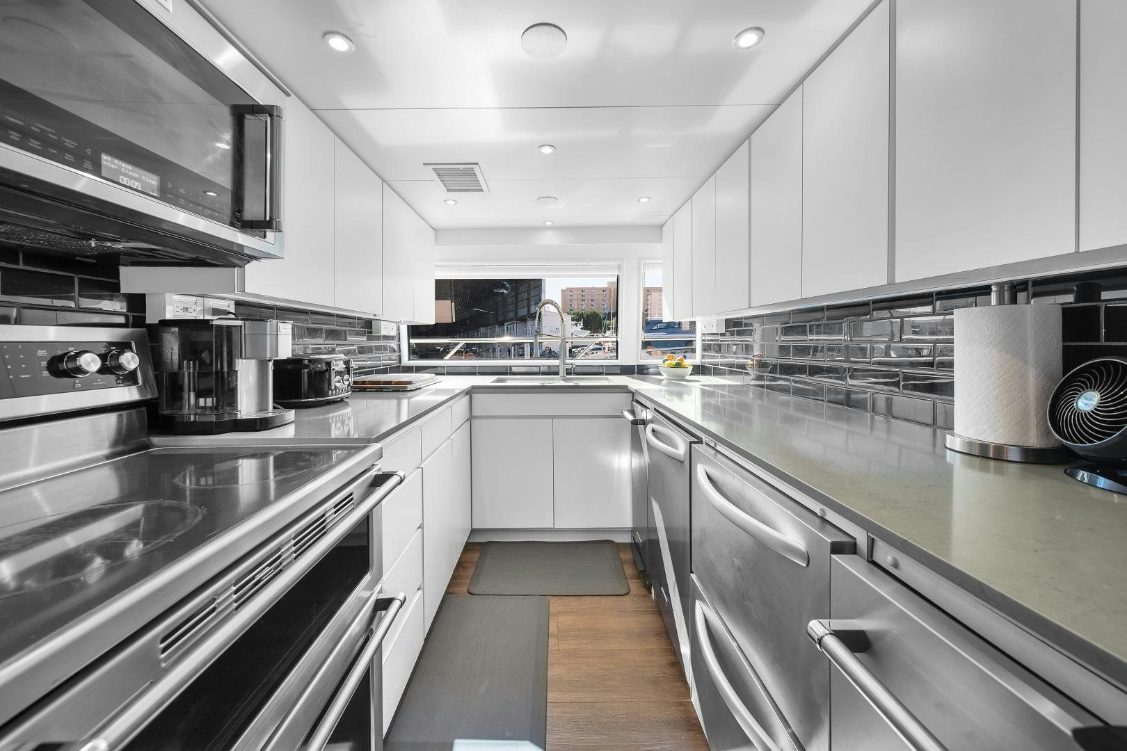 a kitchen with stainless steel appliances aboard A PLACE IN THE SUN Yacht for Sale