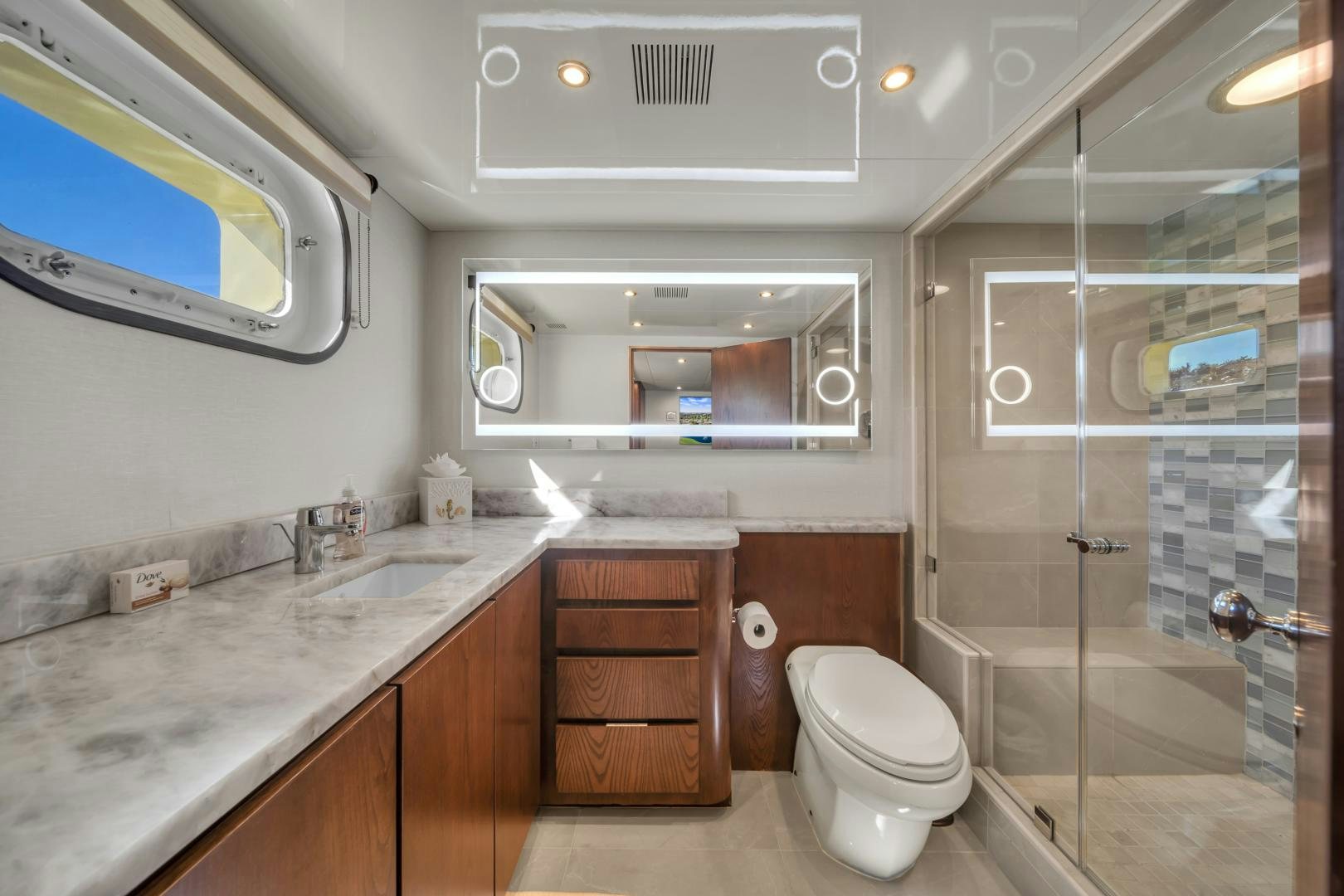 a bathroom with a glass shower aboard A PLACE IN THE SUN Yacht for Sale