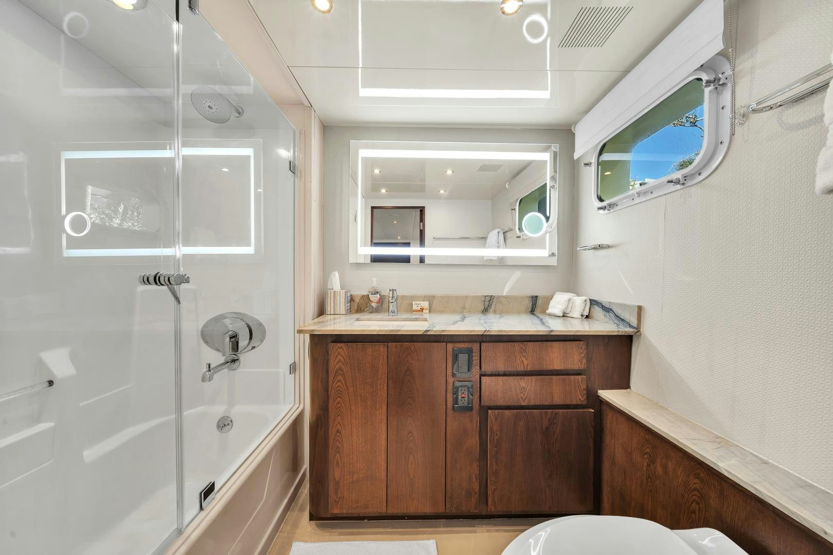 a bathroom with a glass shower aboard A PLACE IN THE SUN Yacht for Sale