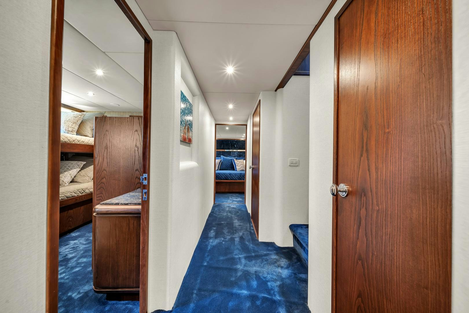 a hallway with a wood door aboard A PLACE IN THE SUN Yacht for Sale