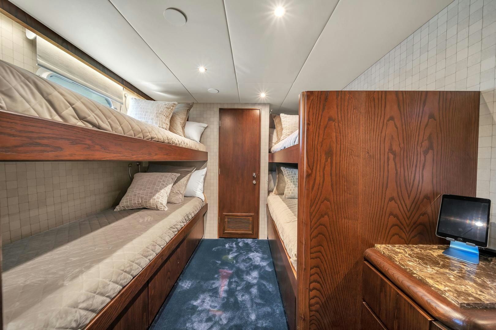 a room with a bed and a television aboard A PLACE IN THE SUN Yacht for Sale