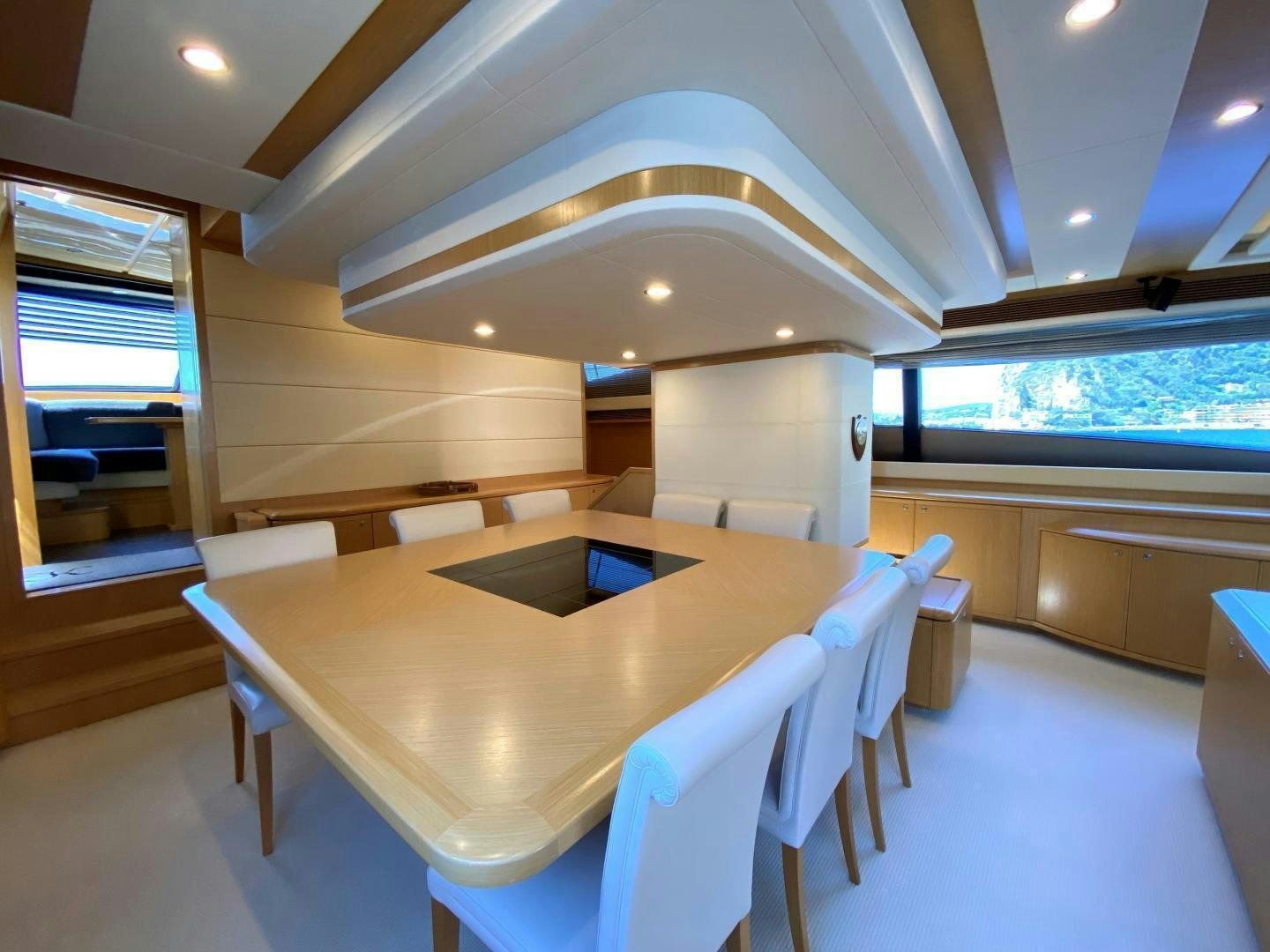 a room with a table and chairs aboard MELI Yacht for Charter