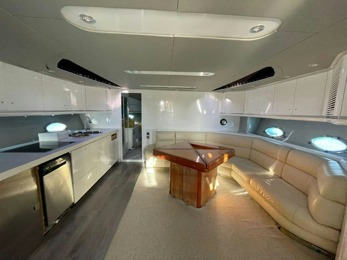 a kitchen with a table and a couch aboard Highlander Yacht for Sale