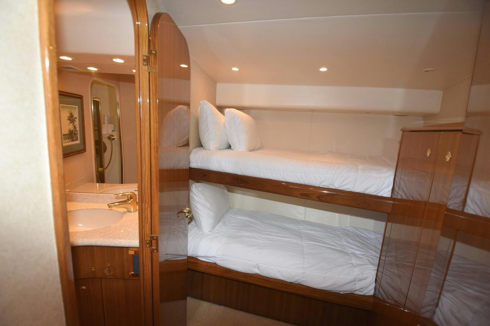 a room with a bed and a sink aboard Hoof Hearted Yacht for Sale