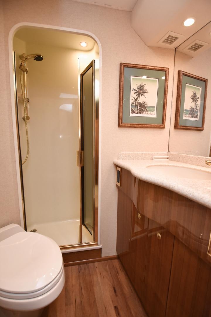 a bathroom with a large mirror aboard Hoof Hearted Yacht for Sale