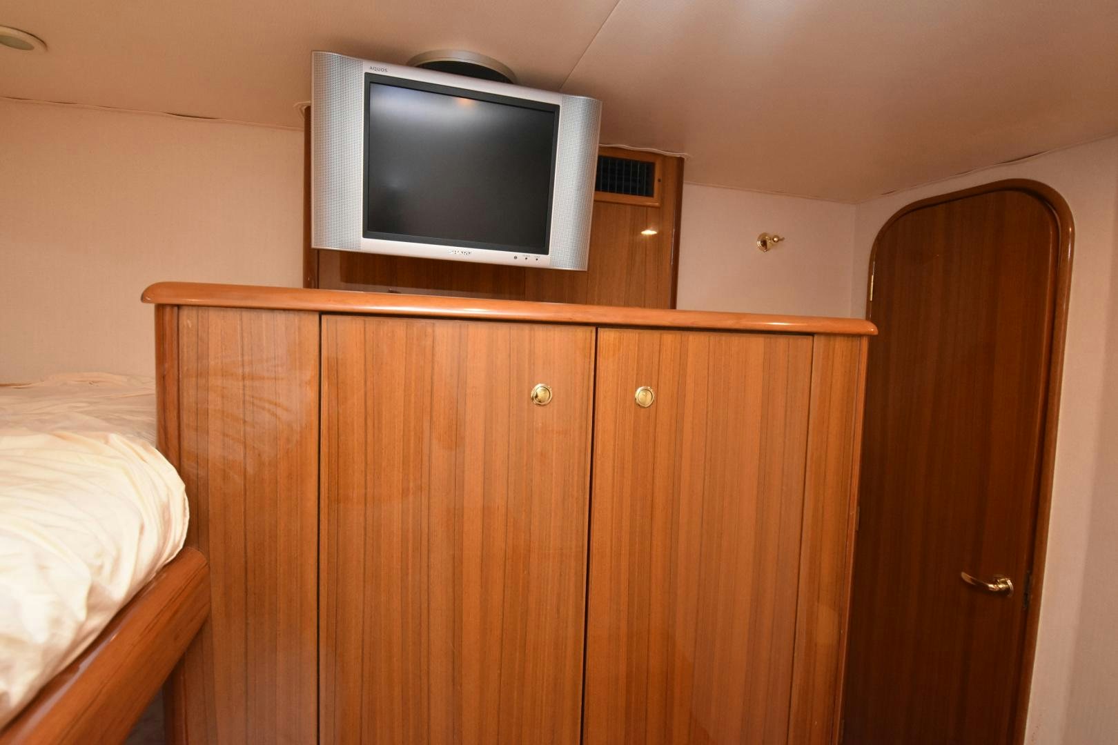 a television on a cabinet aboard Hoof Hearted Yacht for Sale