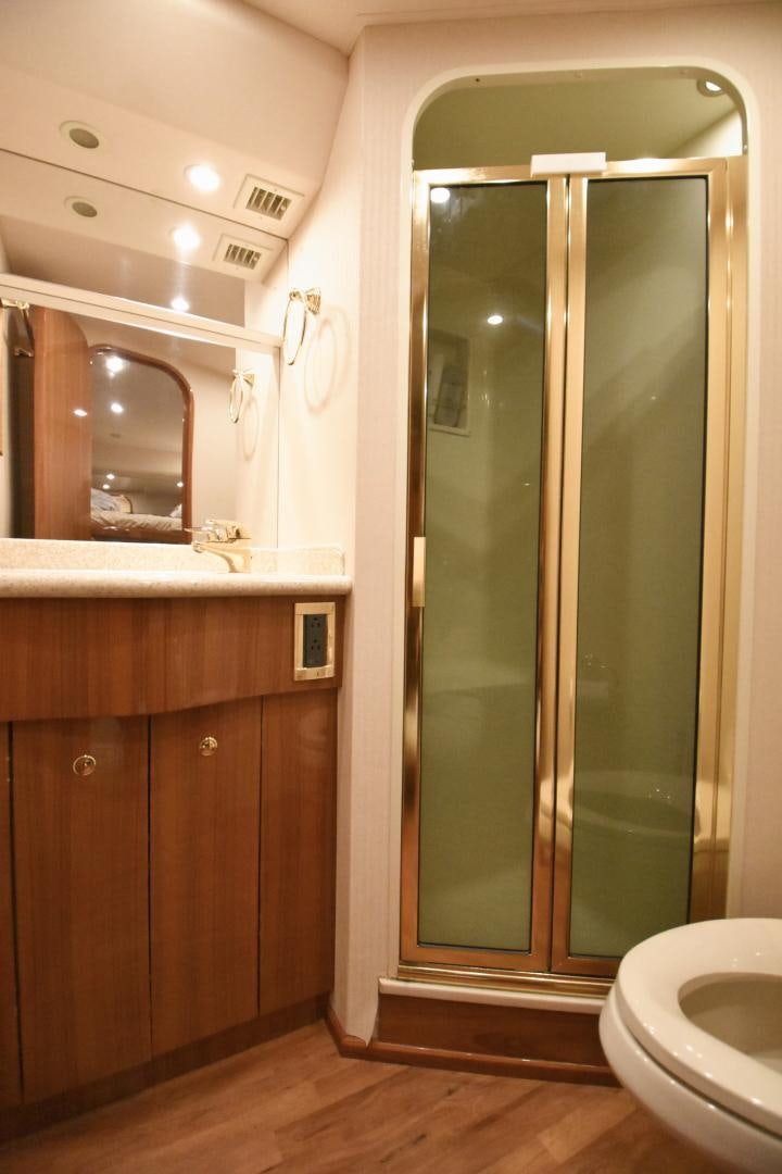 a bathroom with a glass shower door aboard Hoof Hearted Yacht for Sale