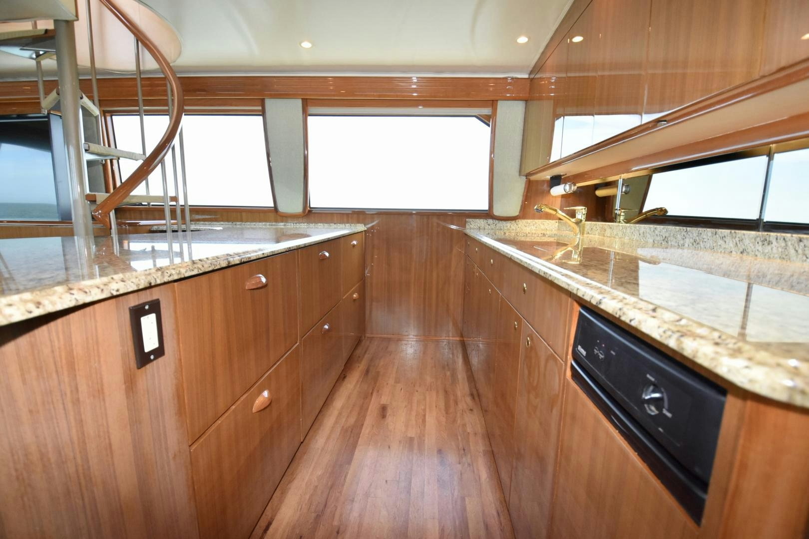 a kitchen with wooden cabinets aboard Hoof Hearted Yacht for Sale