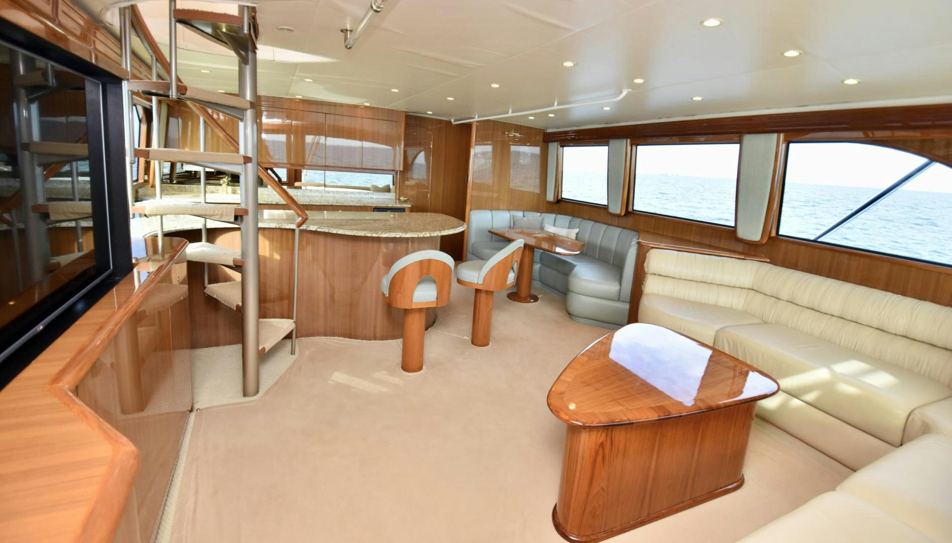 a room with a staircase and a couch aboard Hoof Hearted Yacht for Sale