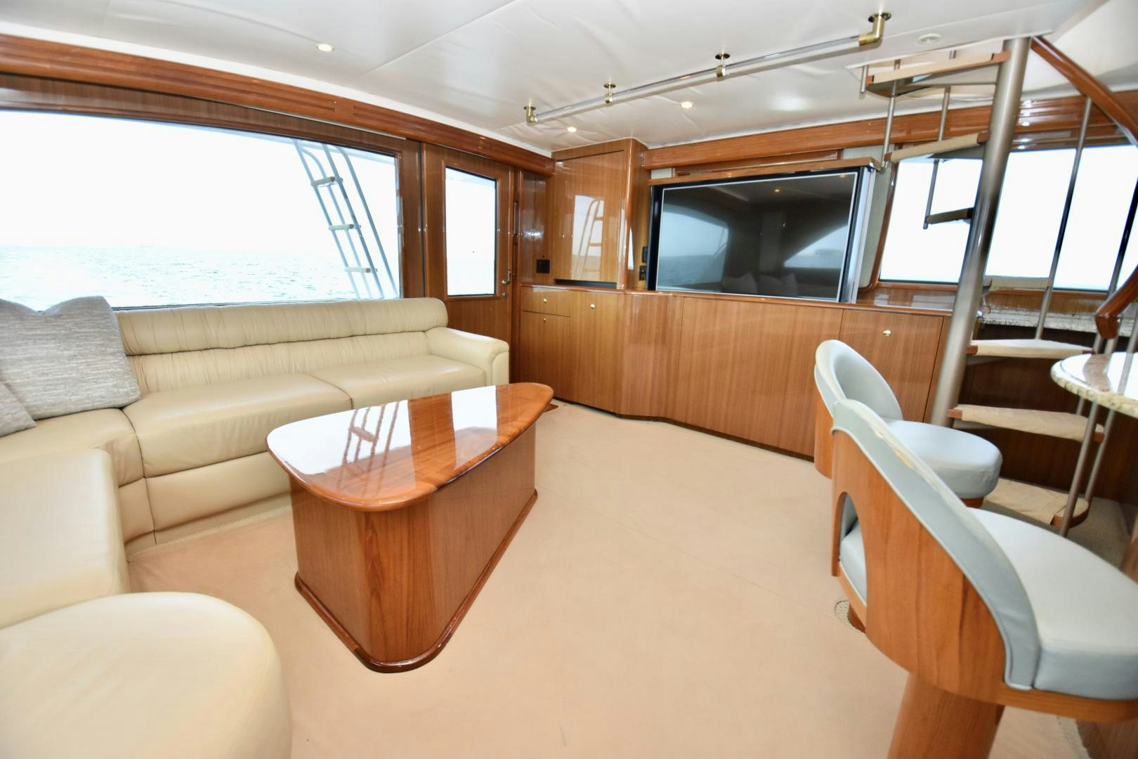 a living room with a couch and a television aboard Hoof Hearted Yacht for Sale
