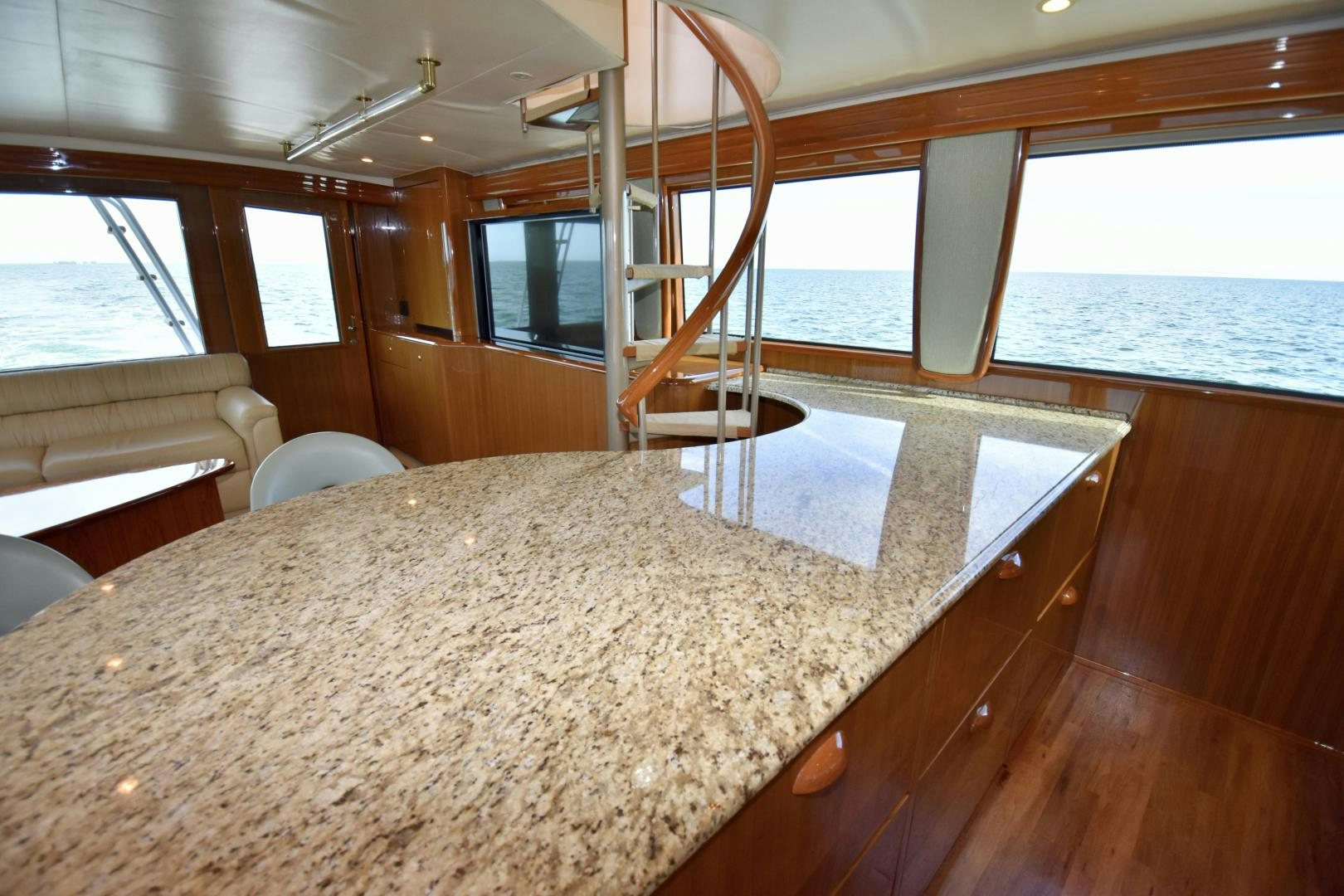 a large room with a large window and a table with chairs aboard Hoof Hearted Yacht for Sale